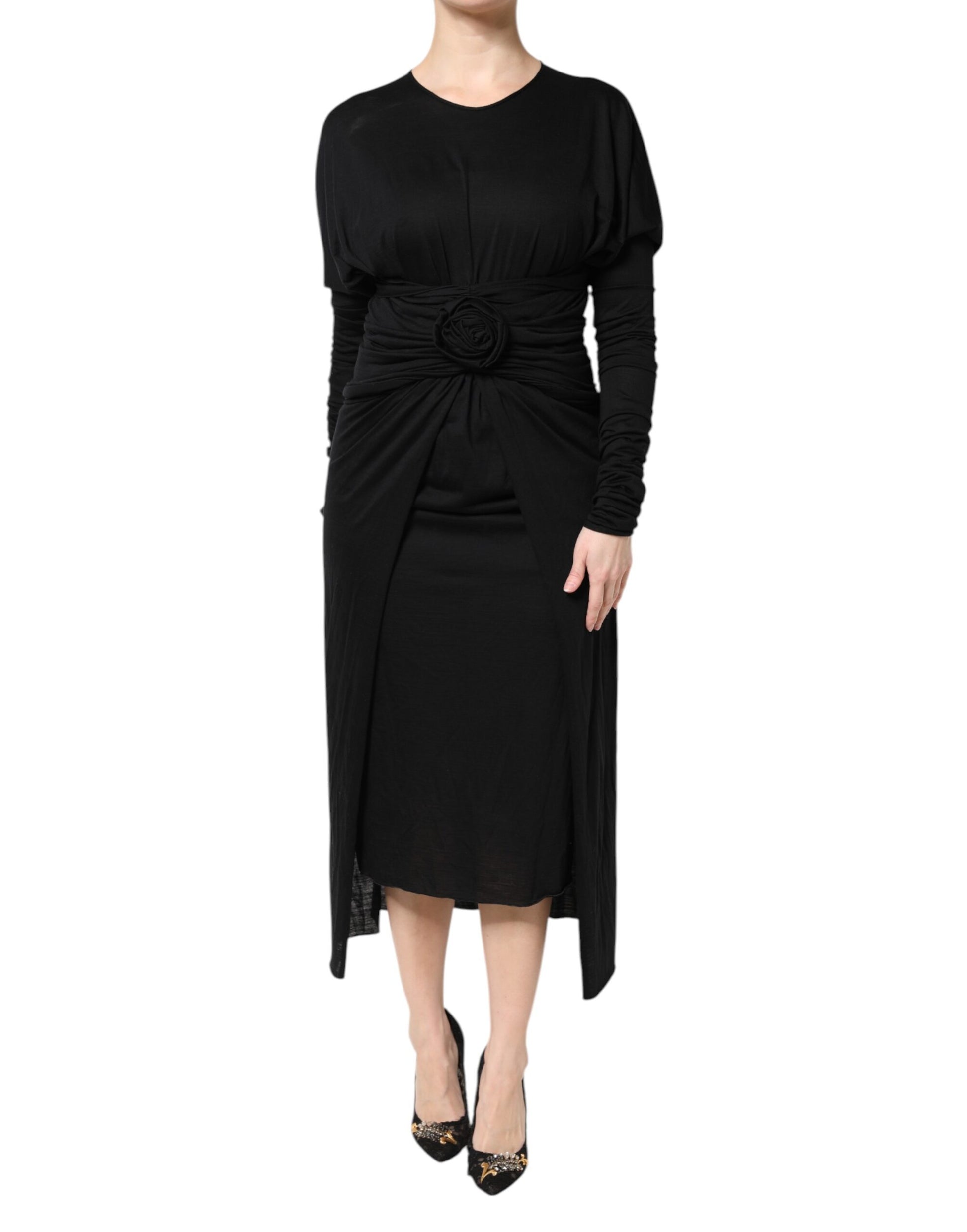 A black wool midi dress with long sleeves and a sheath silhouette