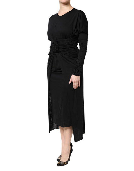 A black wool midi dress with long sleeves and a sheath silhouette