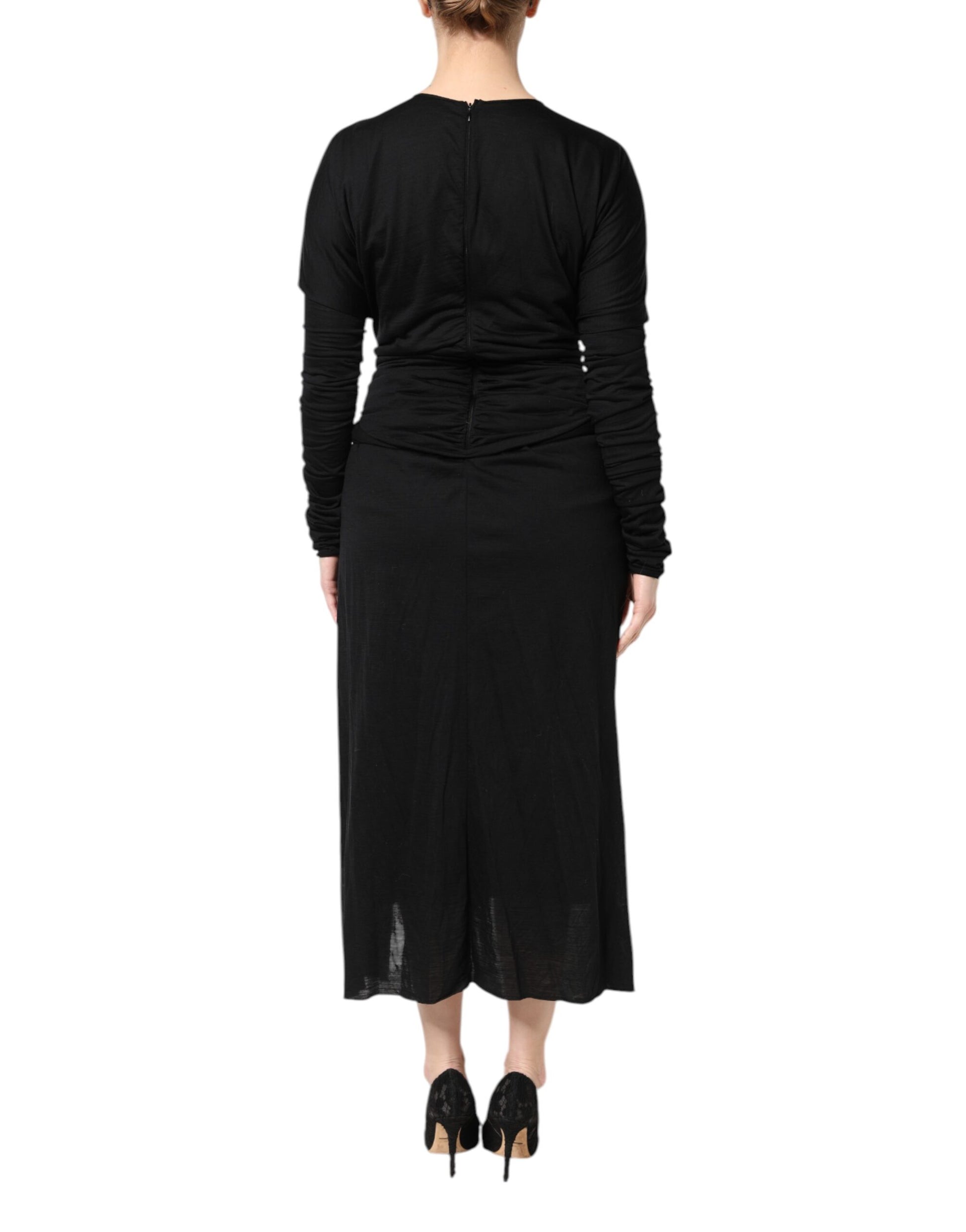 A black wool midi dress with long sleeves and a sheath silhouette