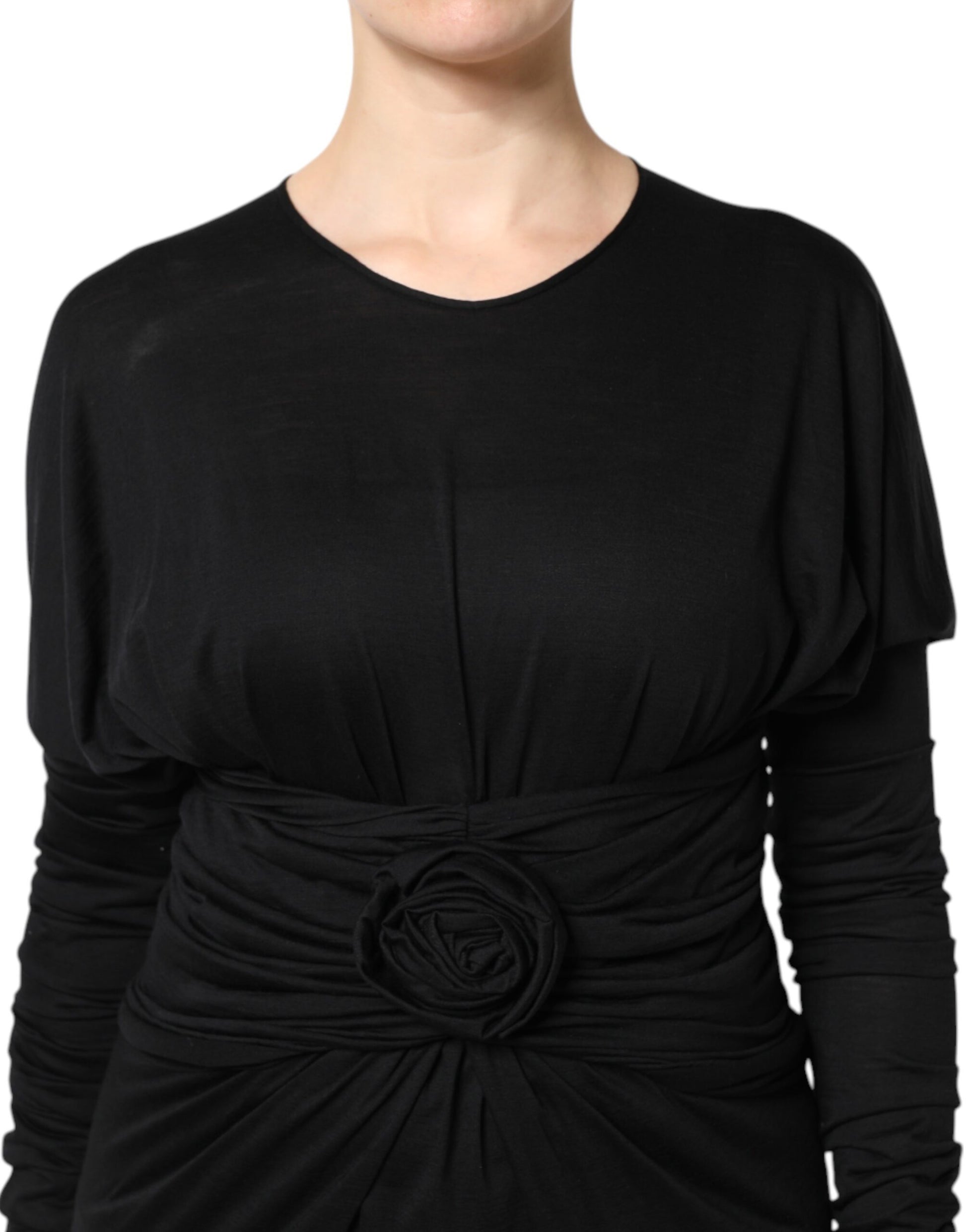 A black wool midi dress with long sleeves and a belted waist