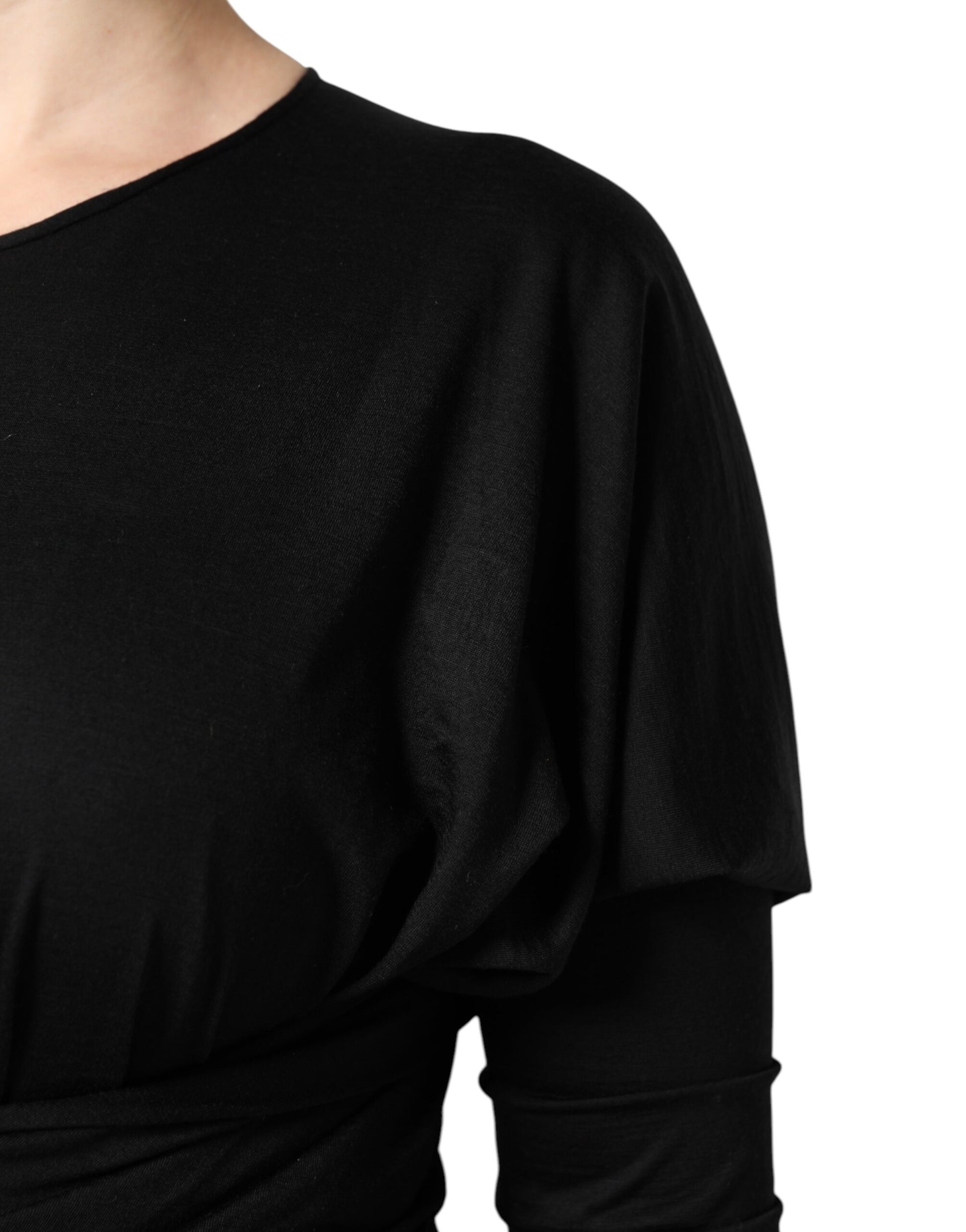 A black wool midi dress with long sleeves and a sheath silhouette
