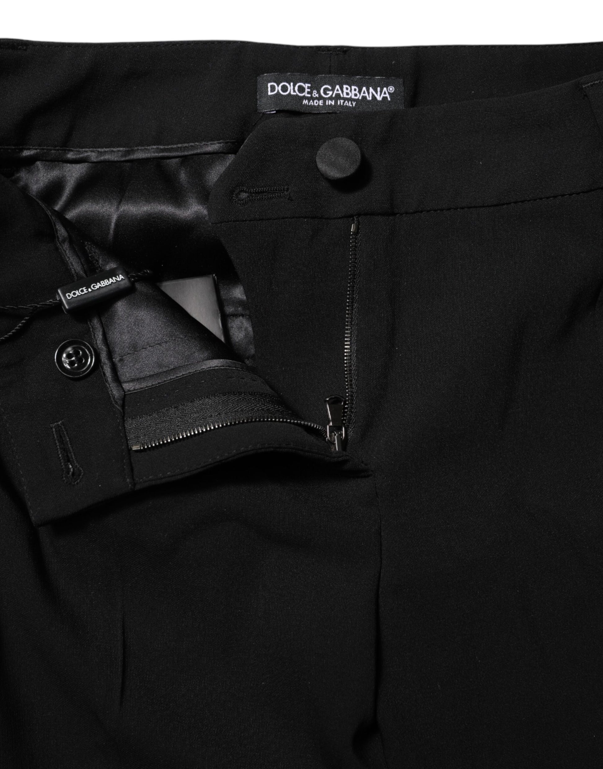 A pair of black wool mid waisted tapered dress pants by Dolce & Gabbana
