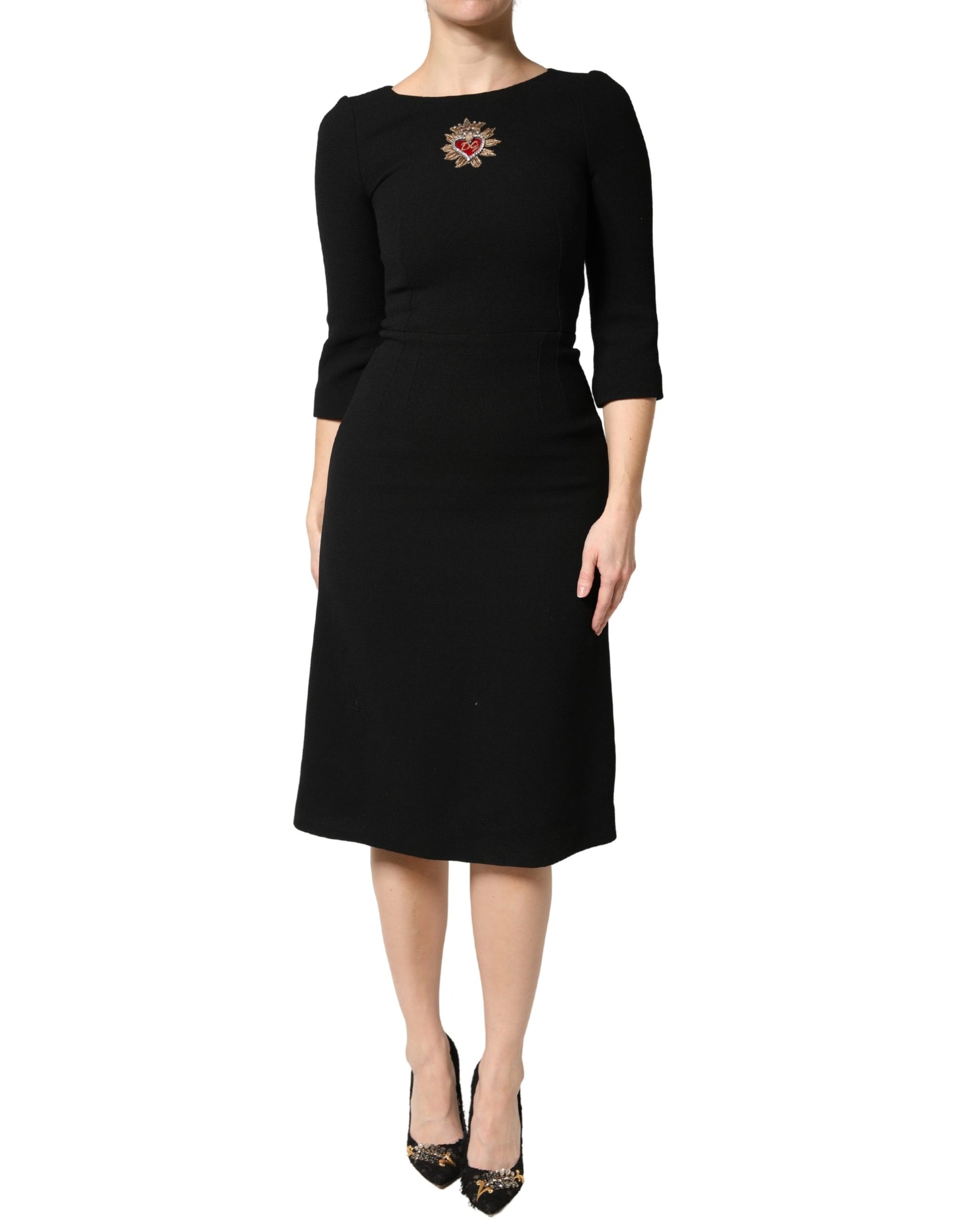 A black midi dress with a sacred heart patch on the chest, designed by Dolce & Gabbana