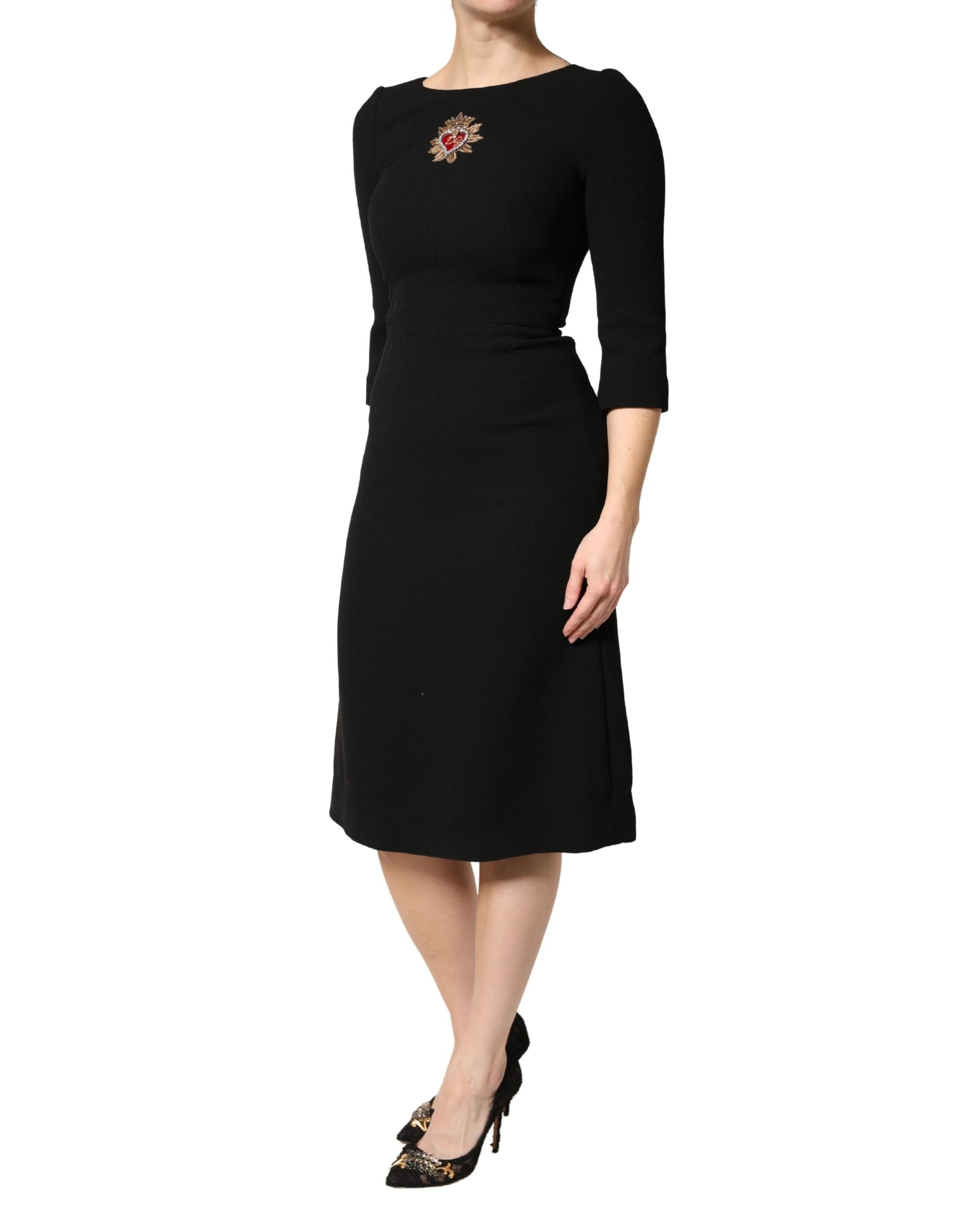 A black midi dress with a sacred heart patch on the front, designed by Dolce & Gabbana