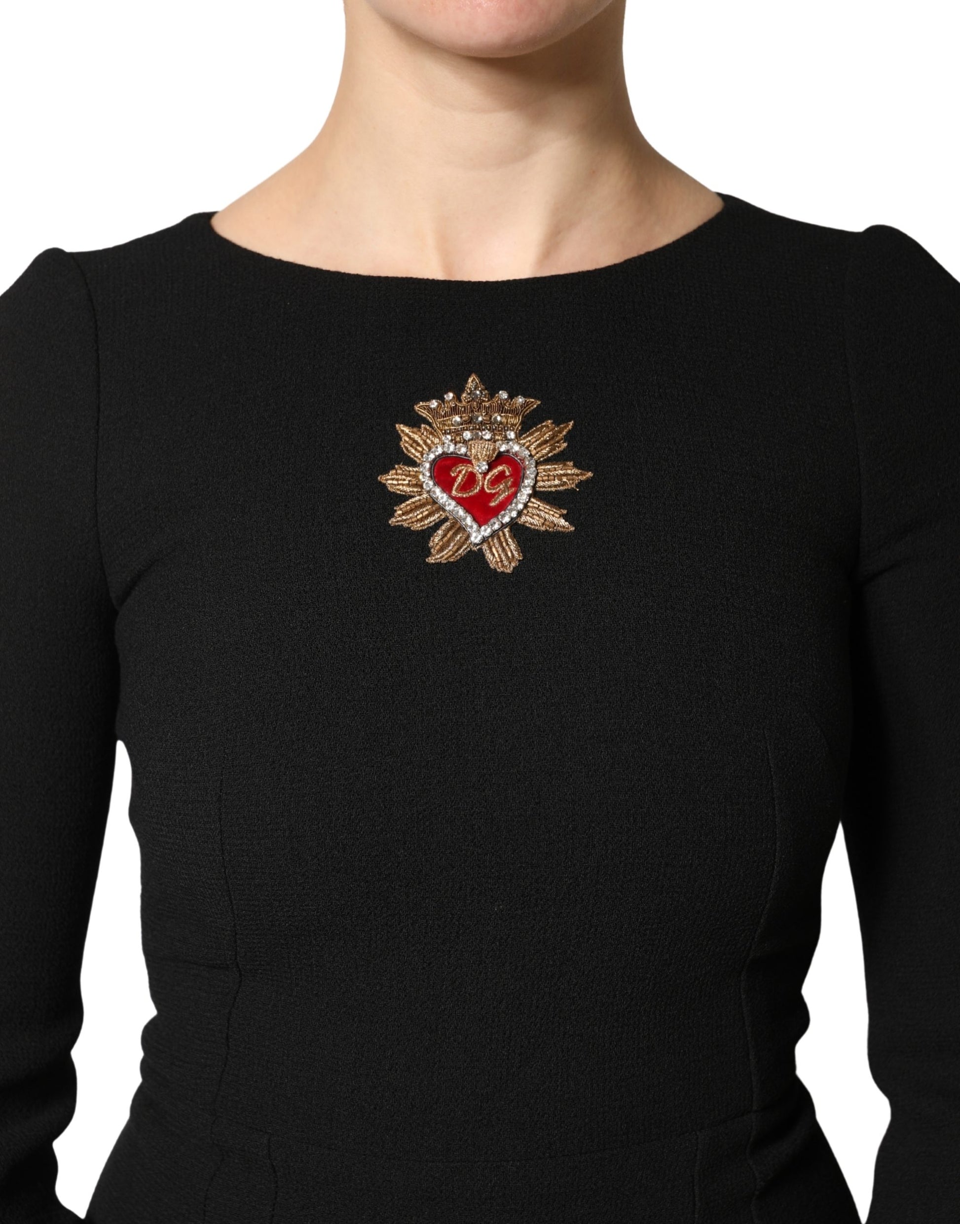 A black wool midi dress with a heart-shaped patch on the chest