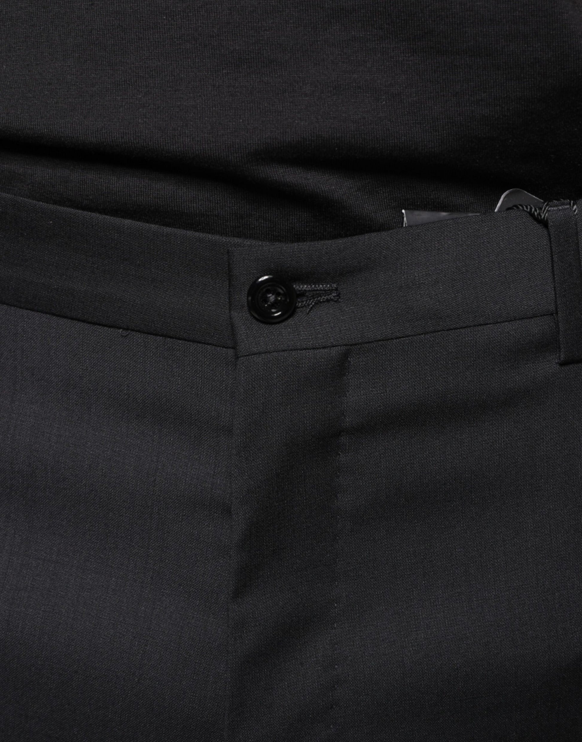 A pair of black wool skinny dress pants with a buttoned front and belt loops