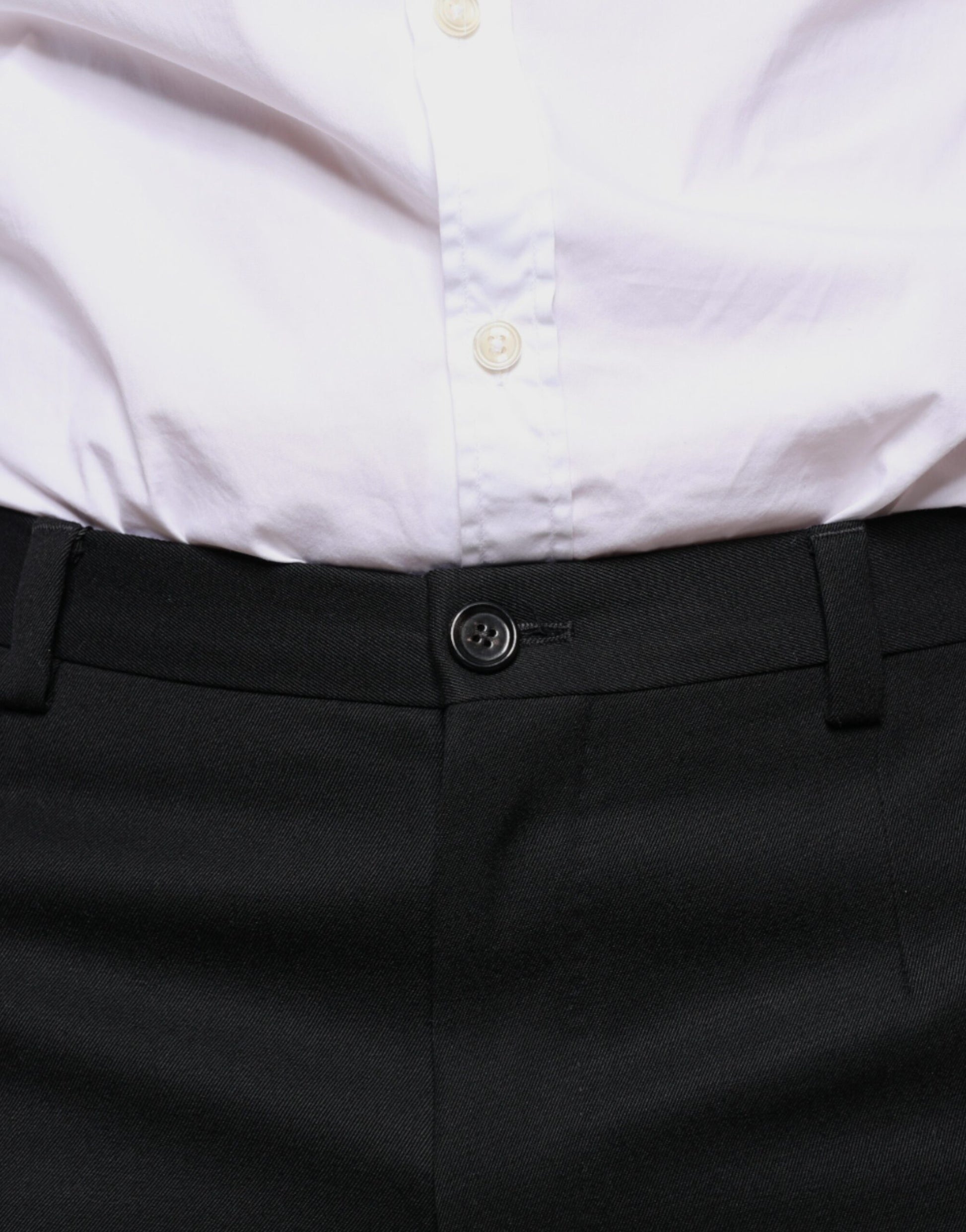 A pair of black wool skinny dress pants with a button and belt loops