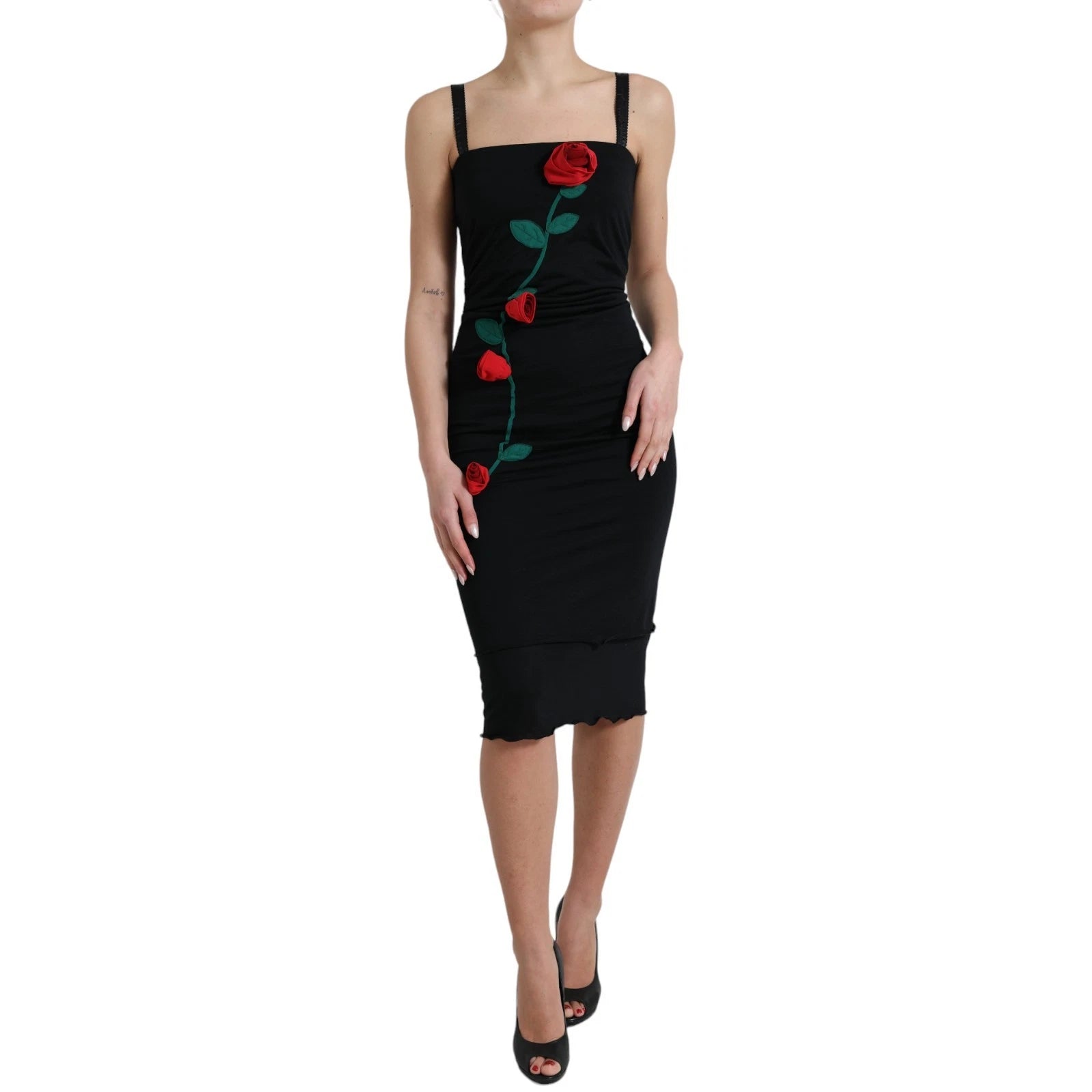 A black sleeveless dress with a rose applique on the side, made of wool