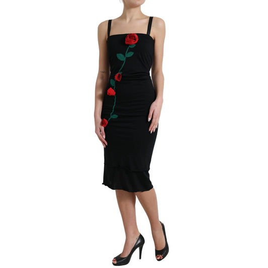 A black sleeveless dress with a rose applique on the front