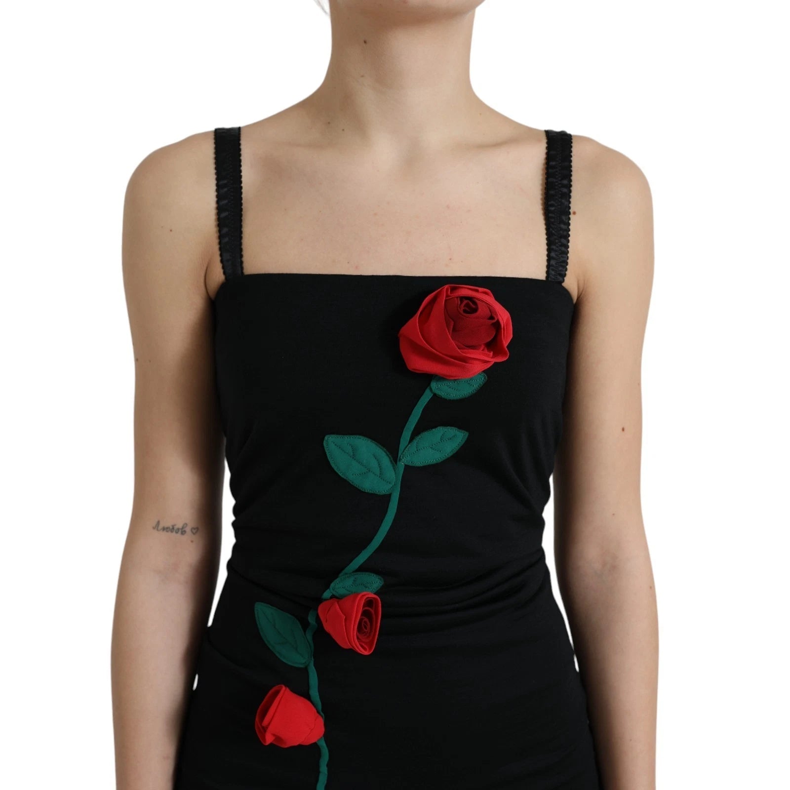 A black sleeveless dress with a rose applique on the chest