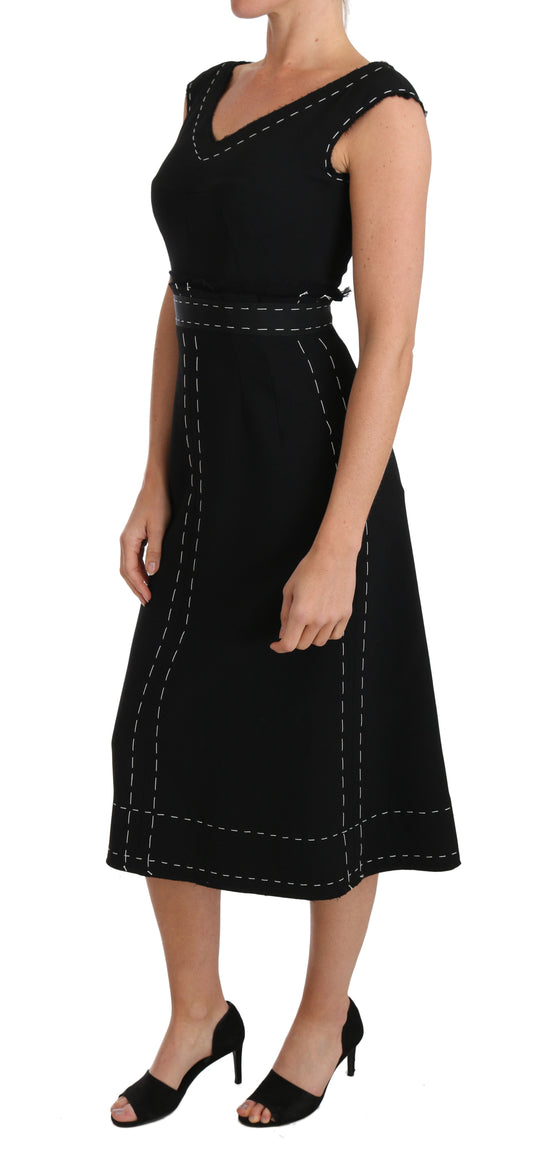A black wool stretch A-line sheath dress from the brand Dolce & Gabbana. It features a fitted bodice with a V