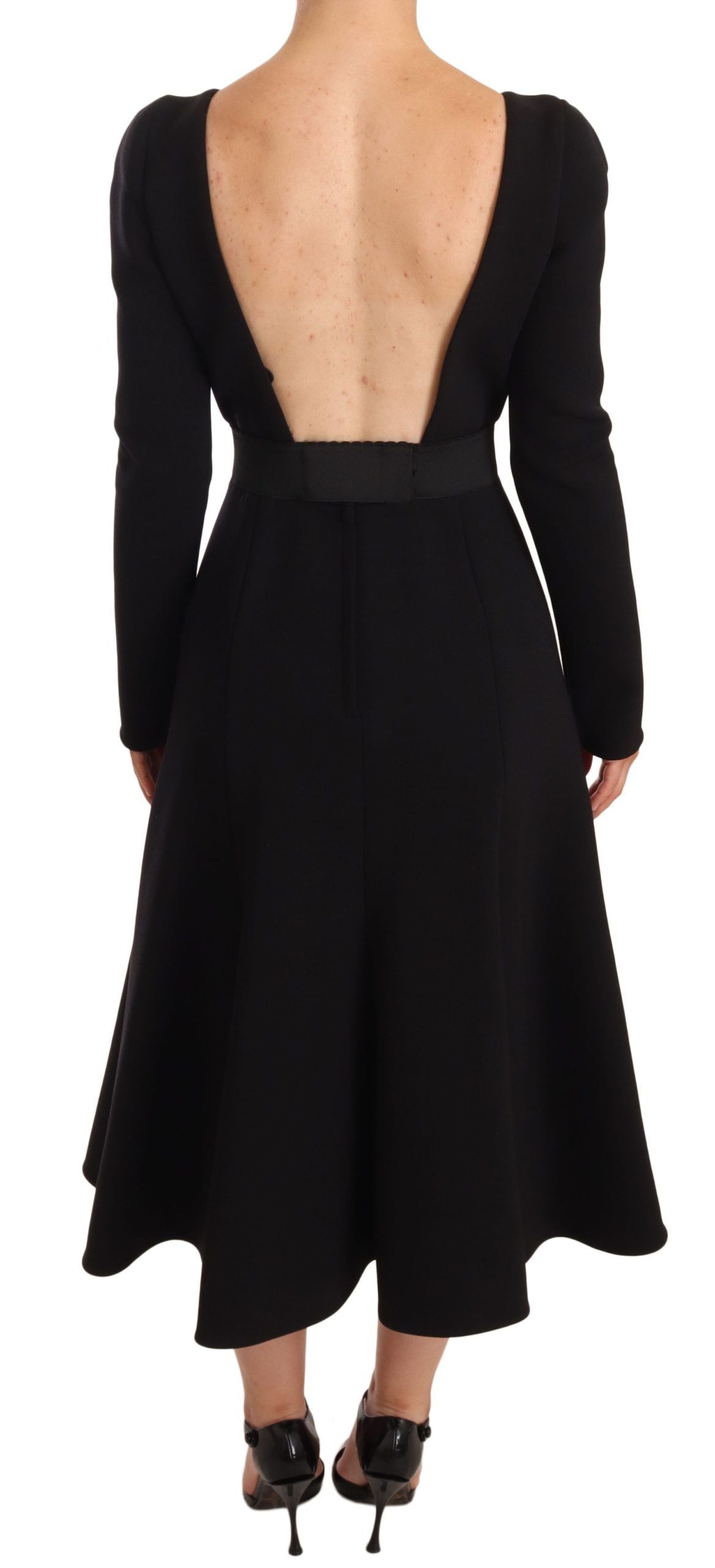 A black wool stretch sheath dress with an open back design, featuring a high neckline and long sleeves
