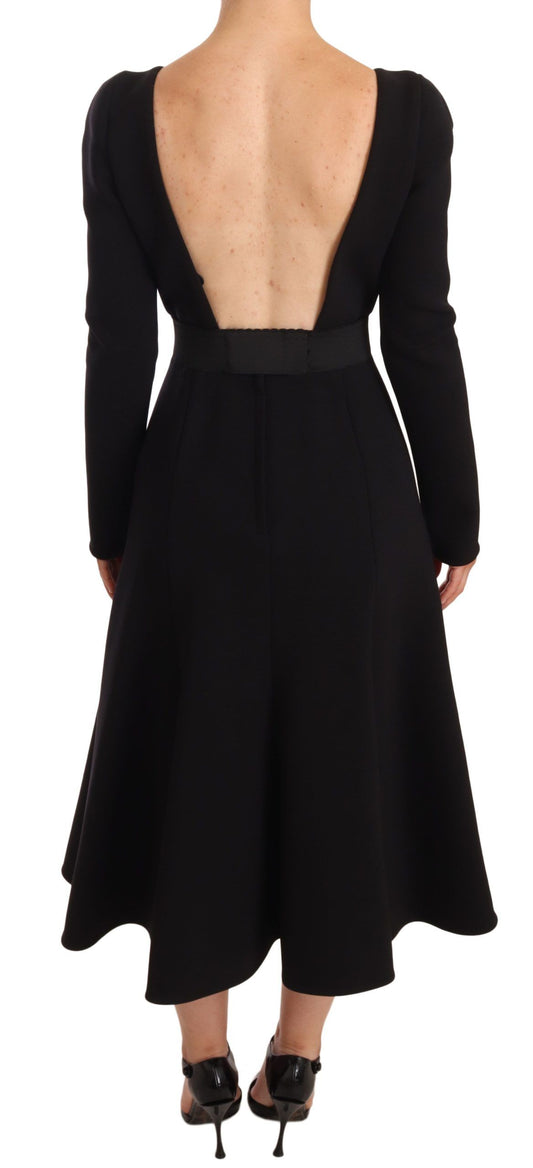 A black wool stretch sheath dress with an open back design, featuring a high neckline and long sleeves