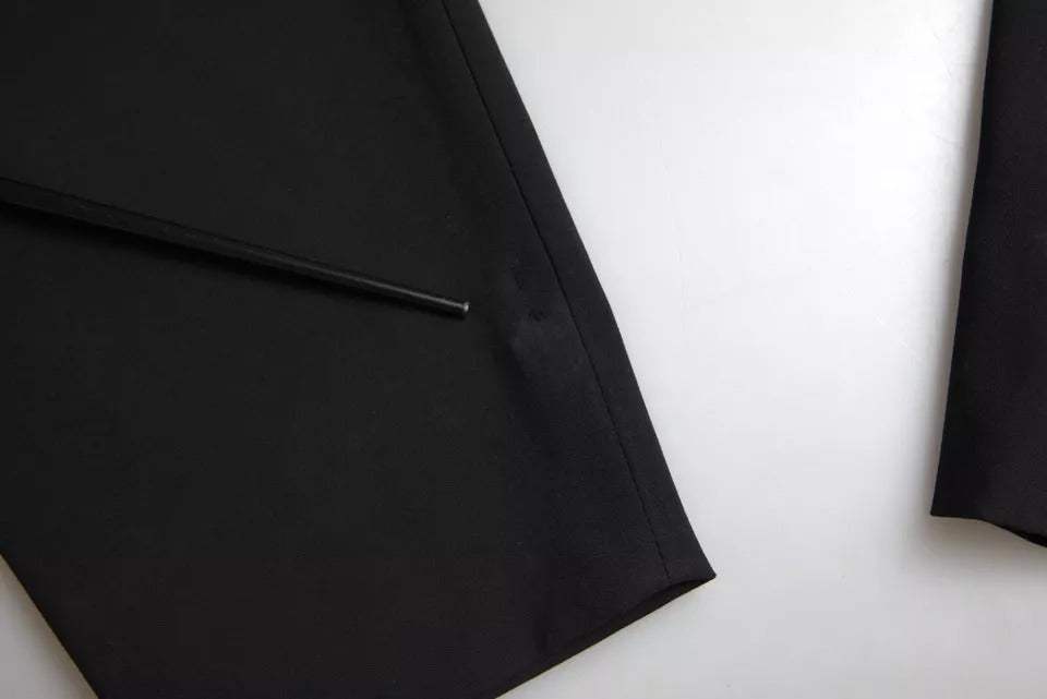 A black wool stretch strapless jumpsuit dress with a slim fit