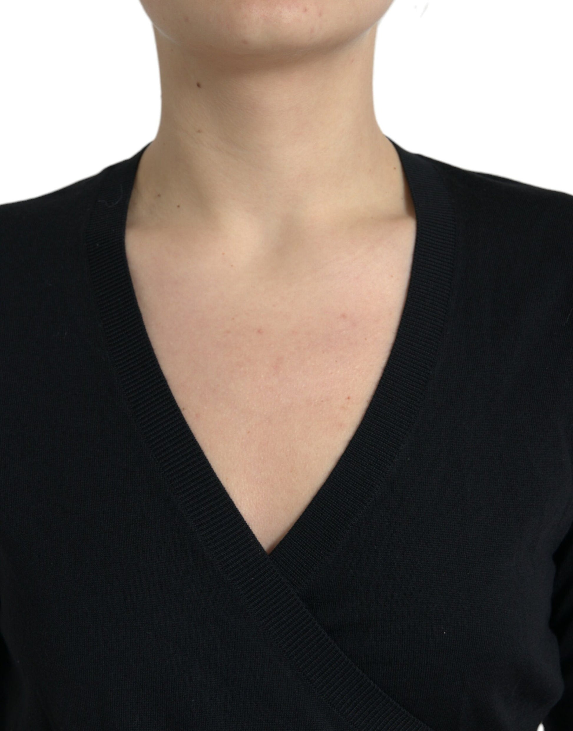 Woman wearing a black v-neck sweater