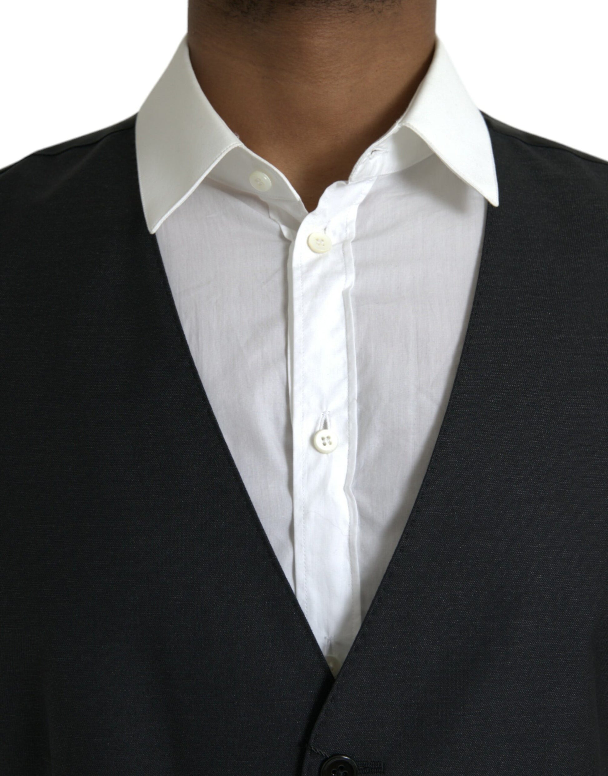 A black wool vest with a white shirt underneath, part of a formal dress suit