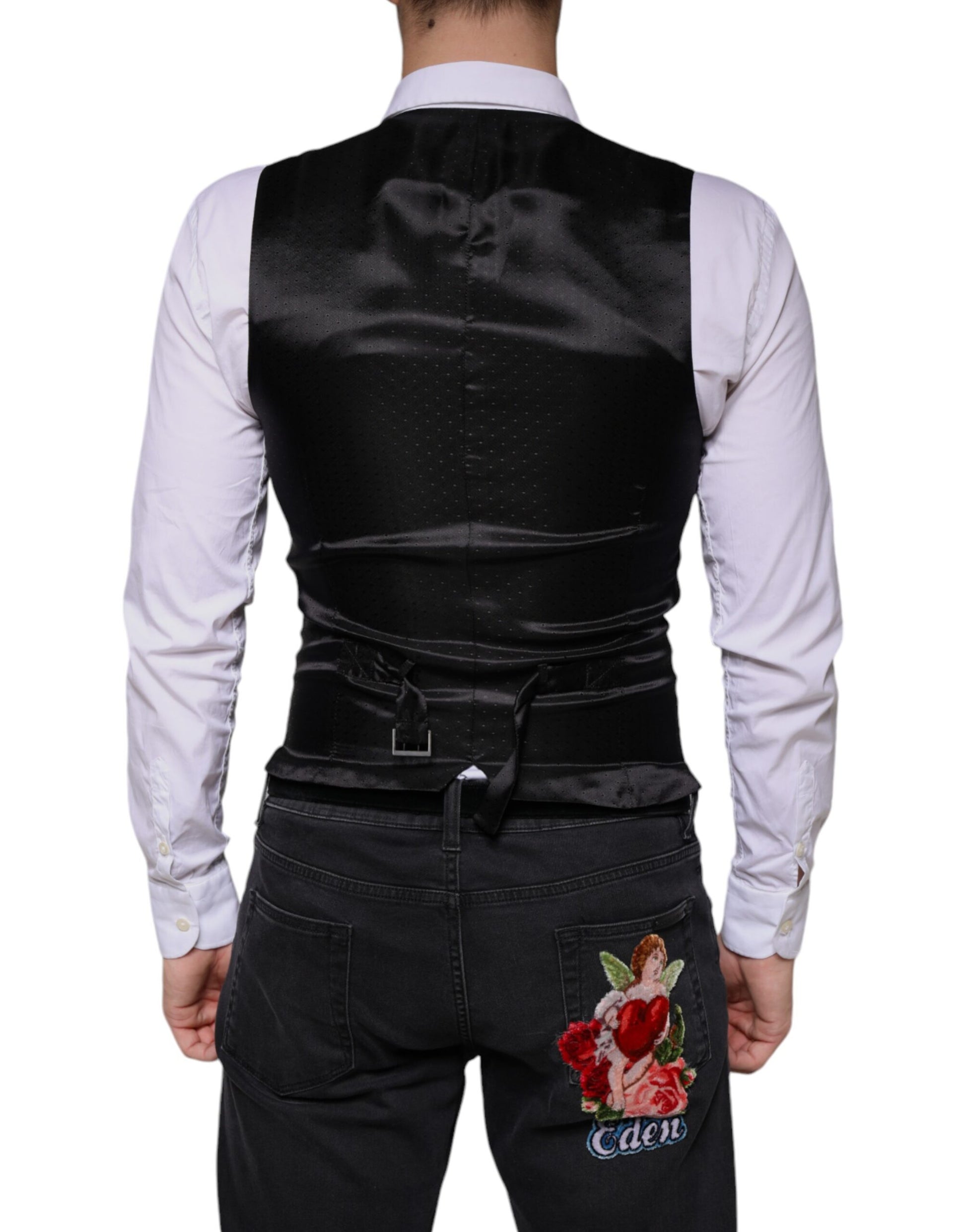 A black wool vest with a floral embroidery on the back