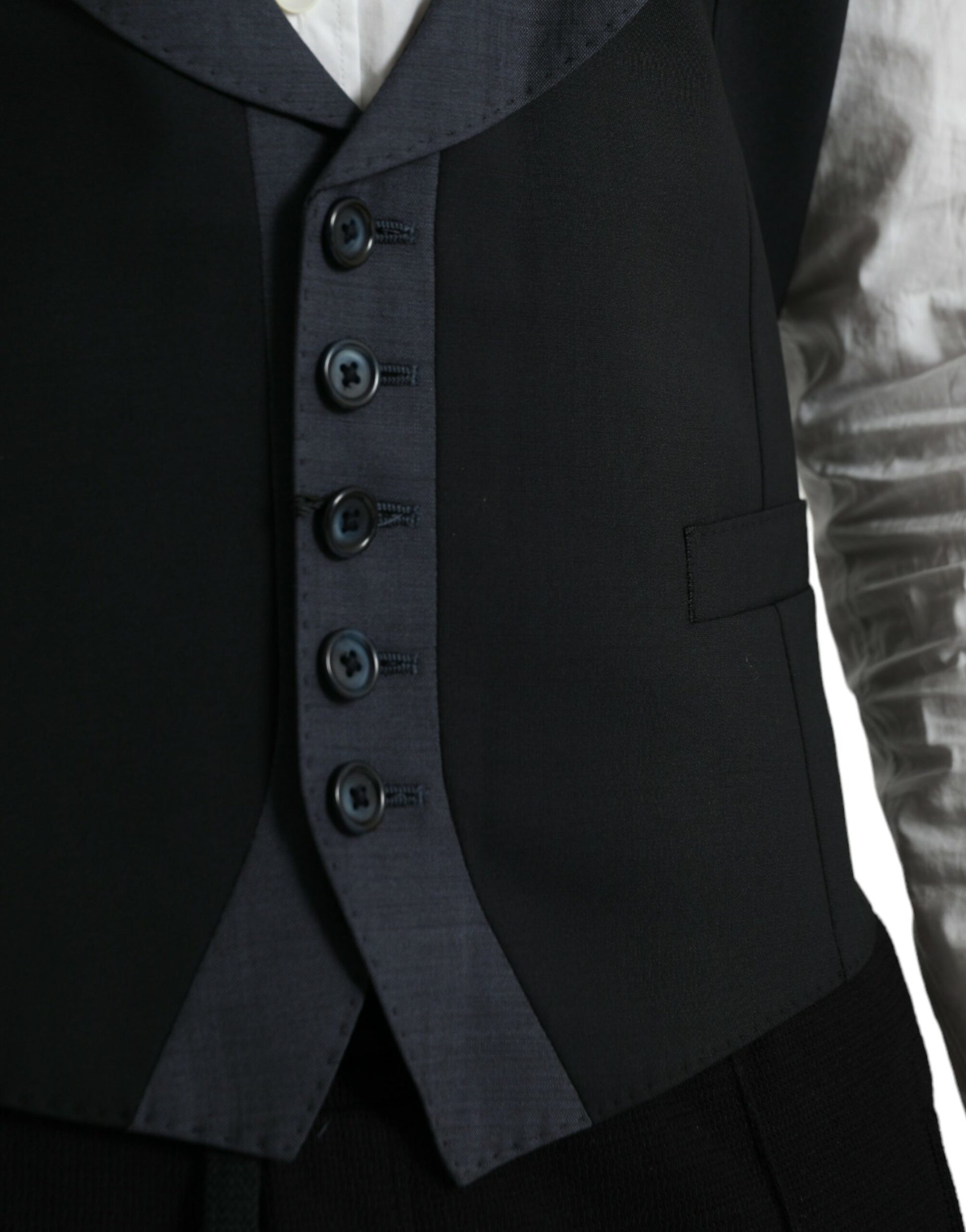 A black wool vest with three buttons, part of a formal dress suit