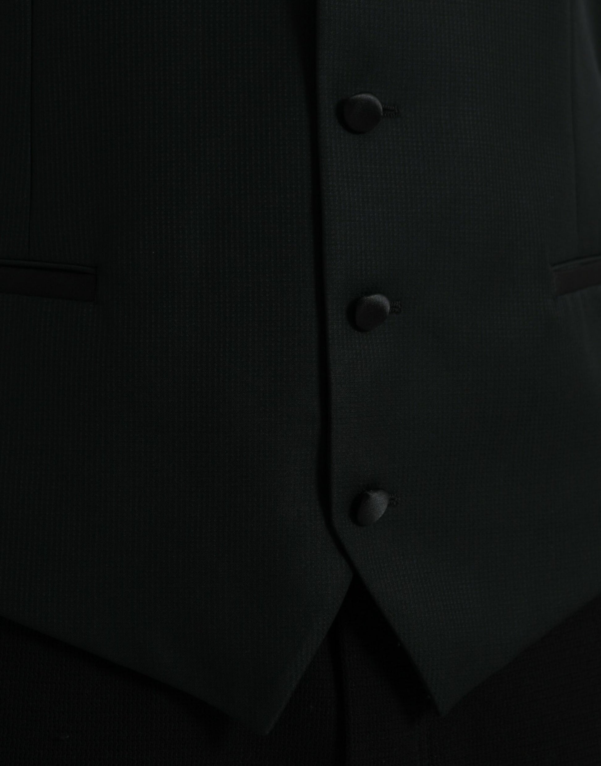 A black wool waistcoat with three buttons, part of a formal dress suit