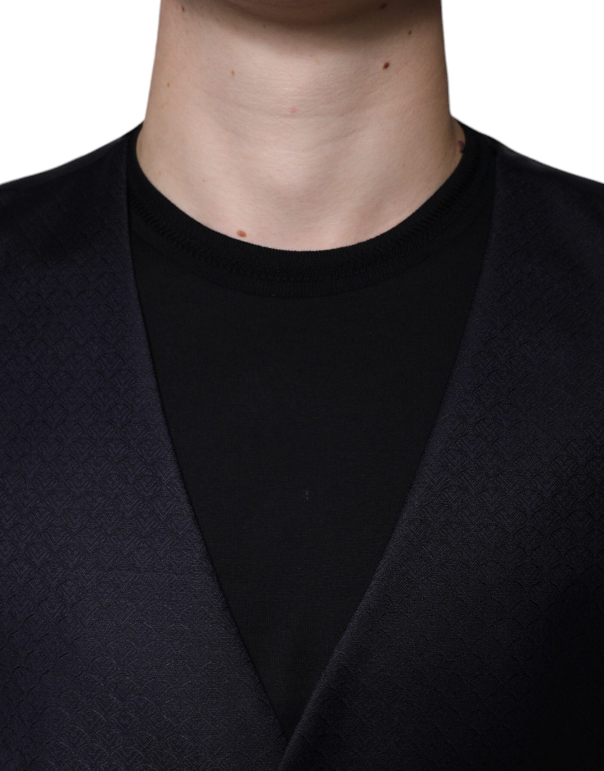 A black wool vest with a notched collar, worn by a mannequin