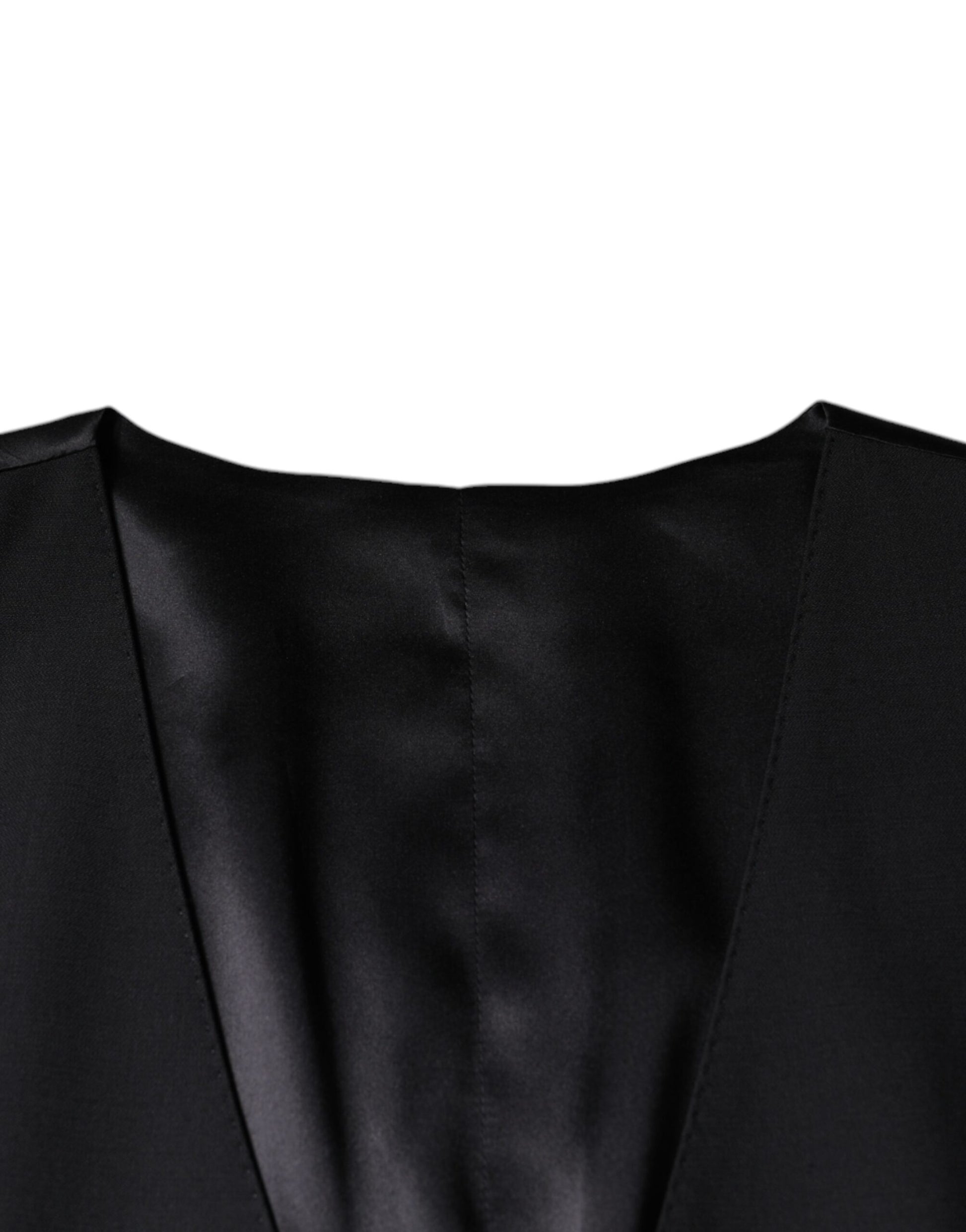 A black wool waistcoat with a textured pattern, part of a formal dress ensemble
