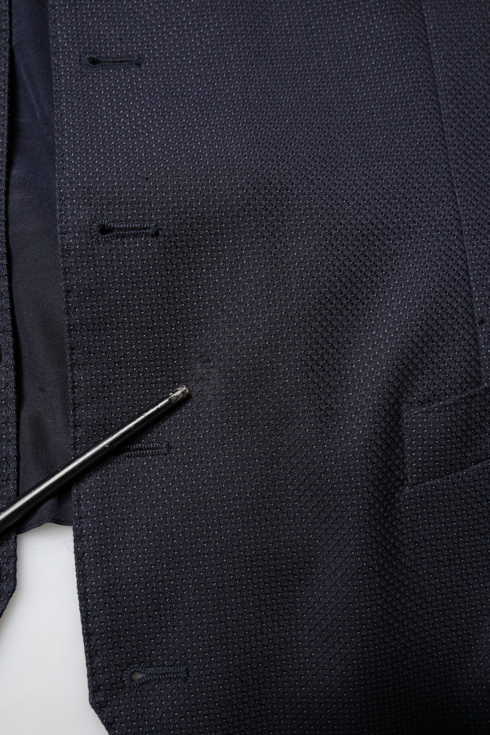 A black wool waistcoat with a textured pattern, part of a formal dress suit
