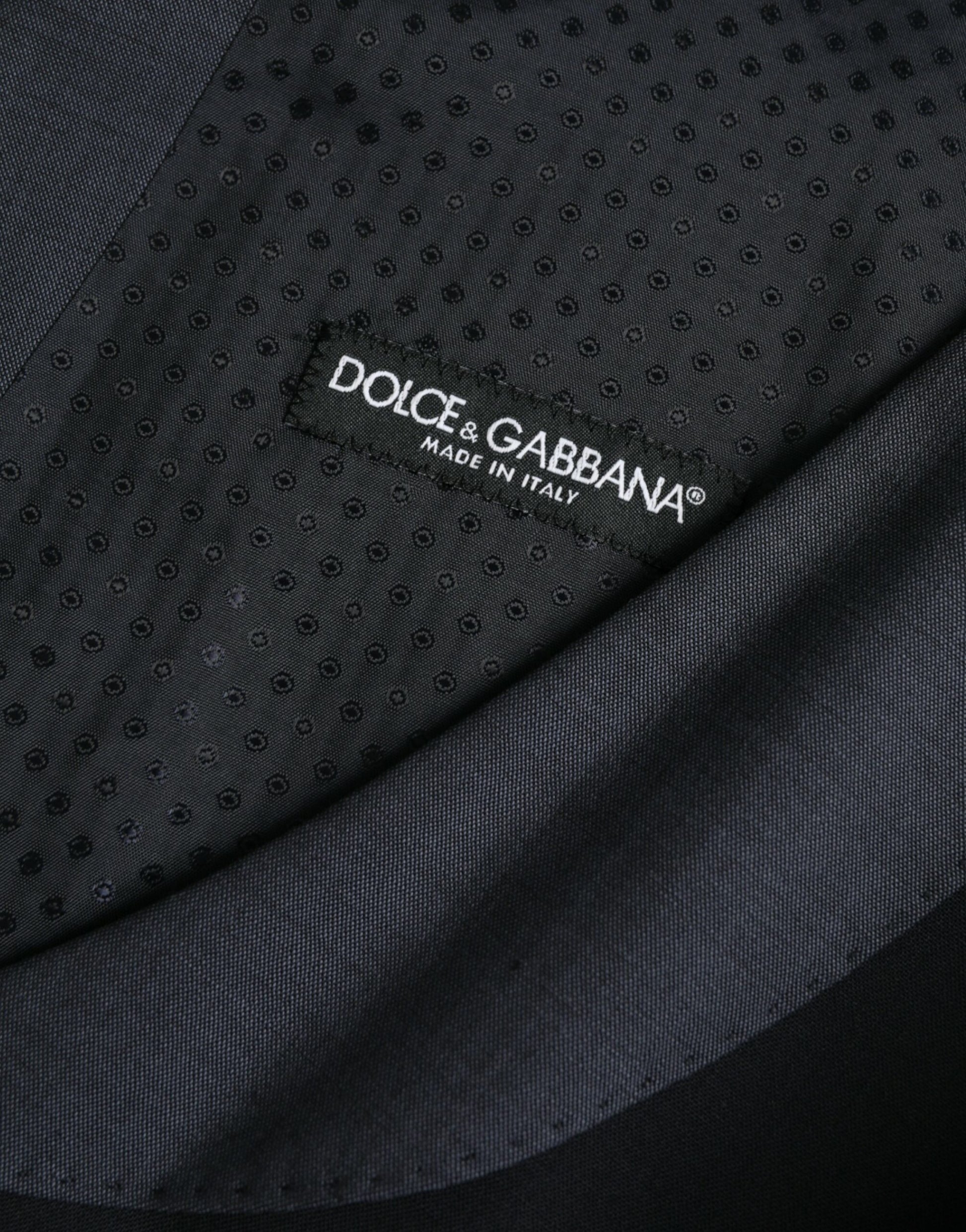 A black wool waistcoat with a label that reads "Dolce & Gabbana" on the back