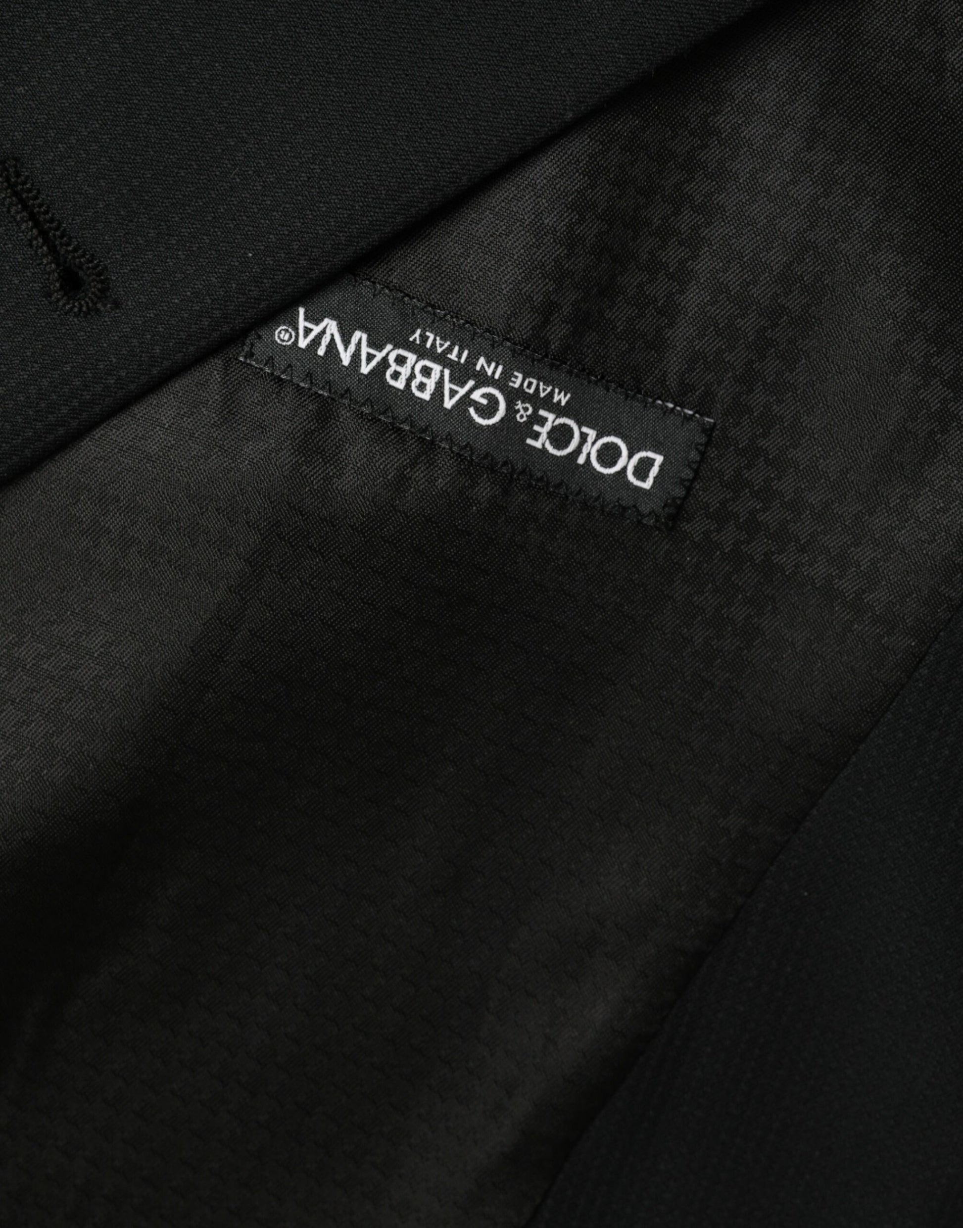 A black wool waistcoat with a label that reads "Dolce & Gabbana"