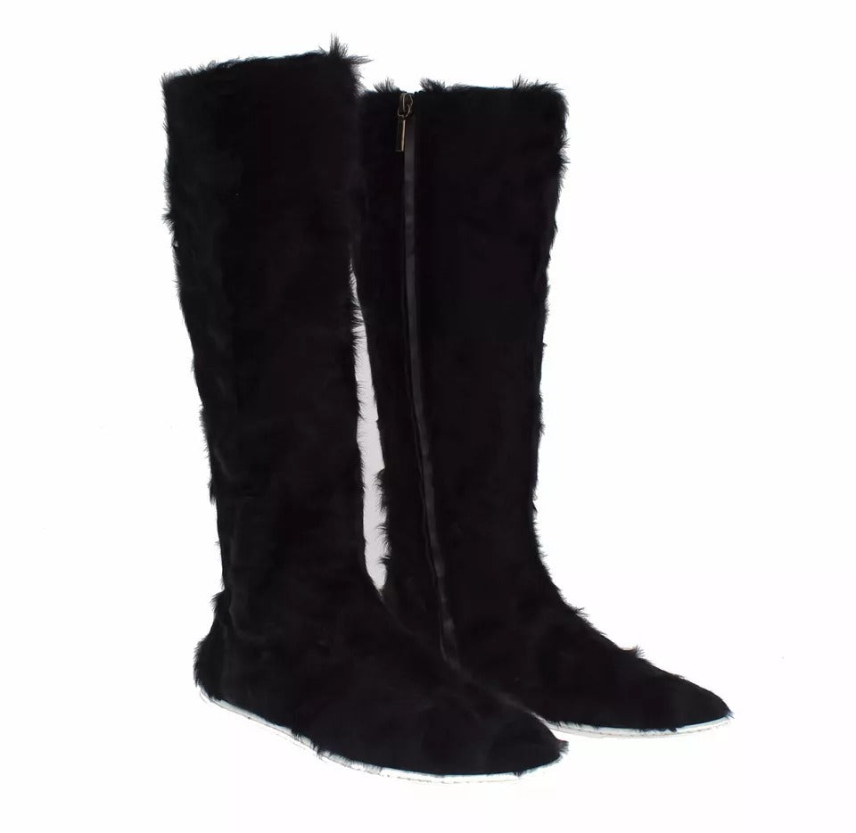 Pair of black fur boots with zipper detailing