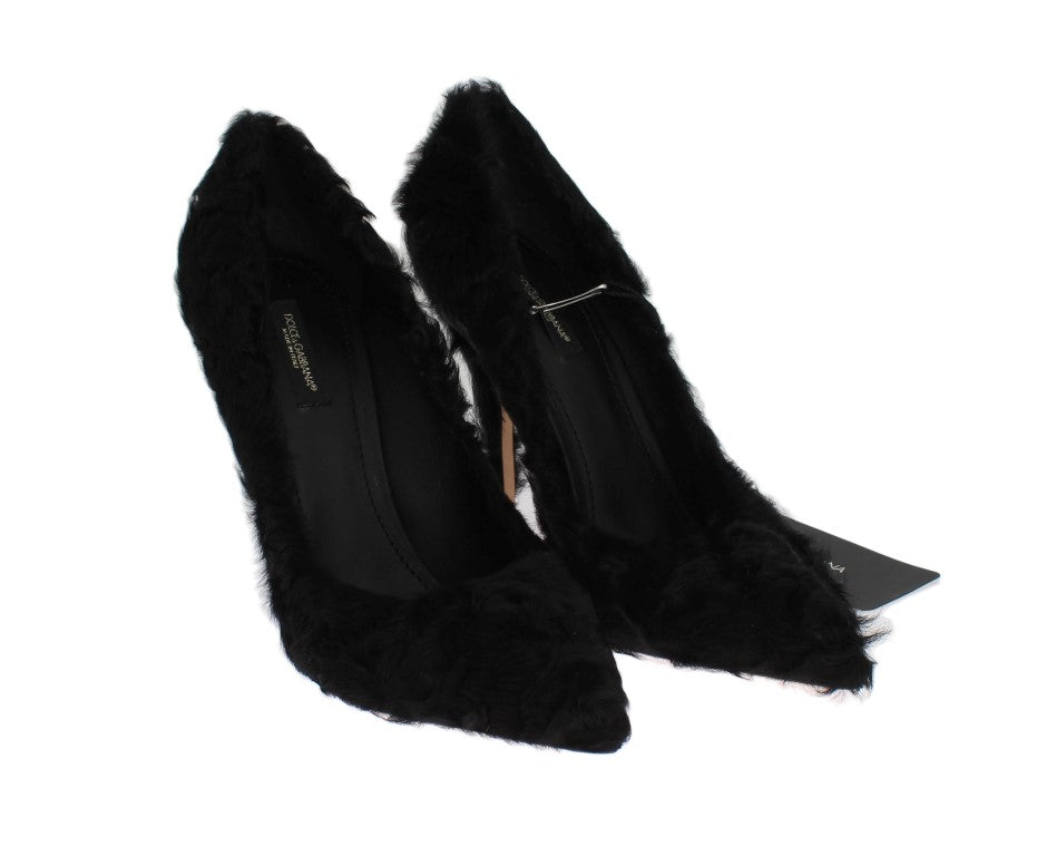 Pair of black furry high heels with a strap over the foot