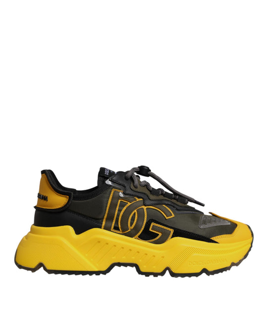 A pair of black and yellow sneakers with a low top, featuring the Dolce & Gabbana logo