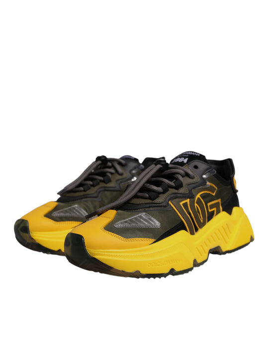 A pair of black and yellow sneakers with a low top, featuring the Dolce & Gabbana logo