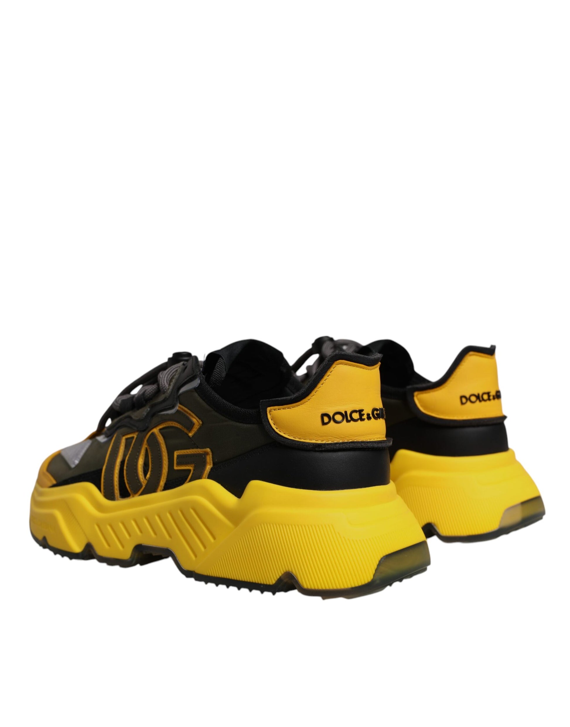 A pair of yellow and black sneakers with a low top, featuring the Dolce & Gabbana logo