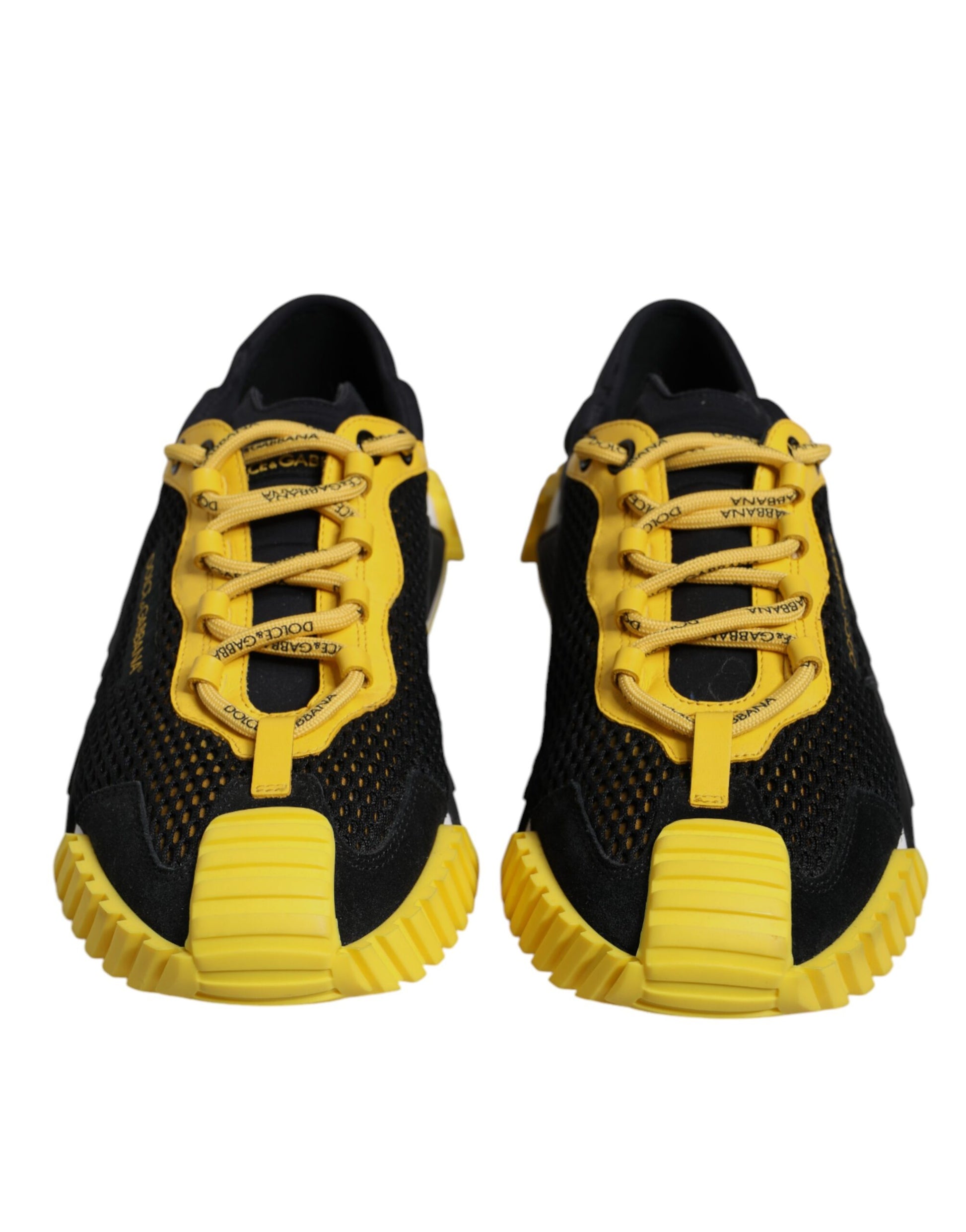 Pair of black and yellow sneakers with laces