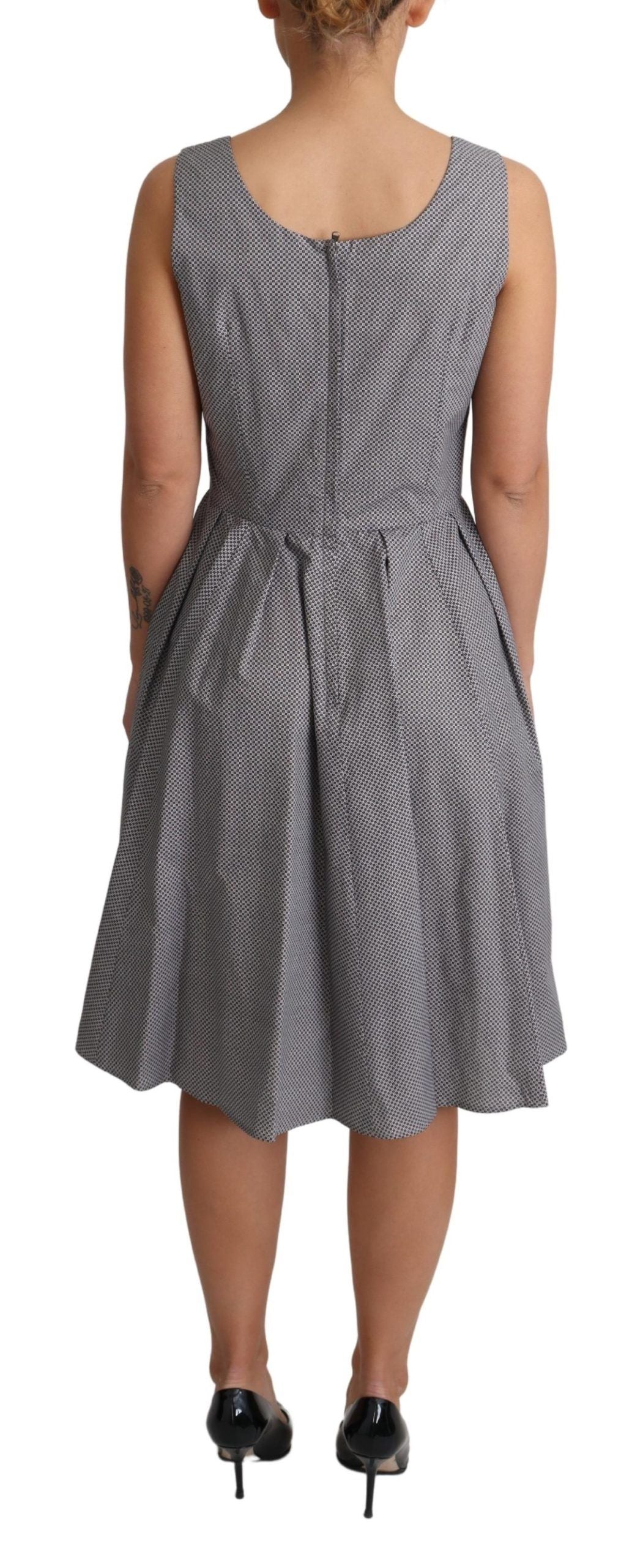 A dress with a geometric pattern in shades of blue and beige, designed by Dolce & Gabbana. It is an A-line st