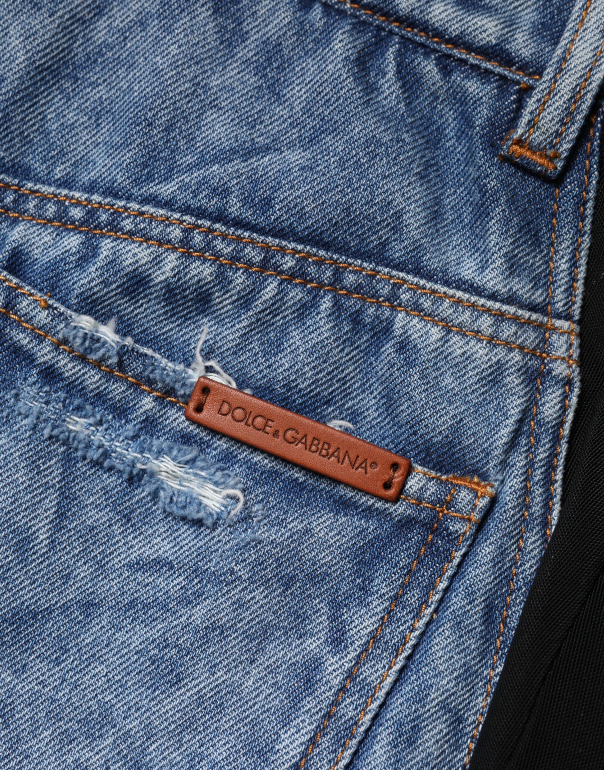 Blue denim jeans with a brown leather patch on the back pocket