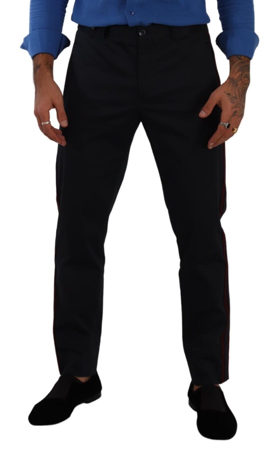 Man wearing black pants with red stripe down side