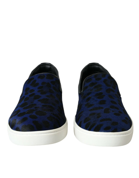 Pair of blue and white slip on shoes with animal print pattern