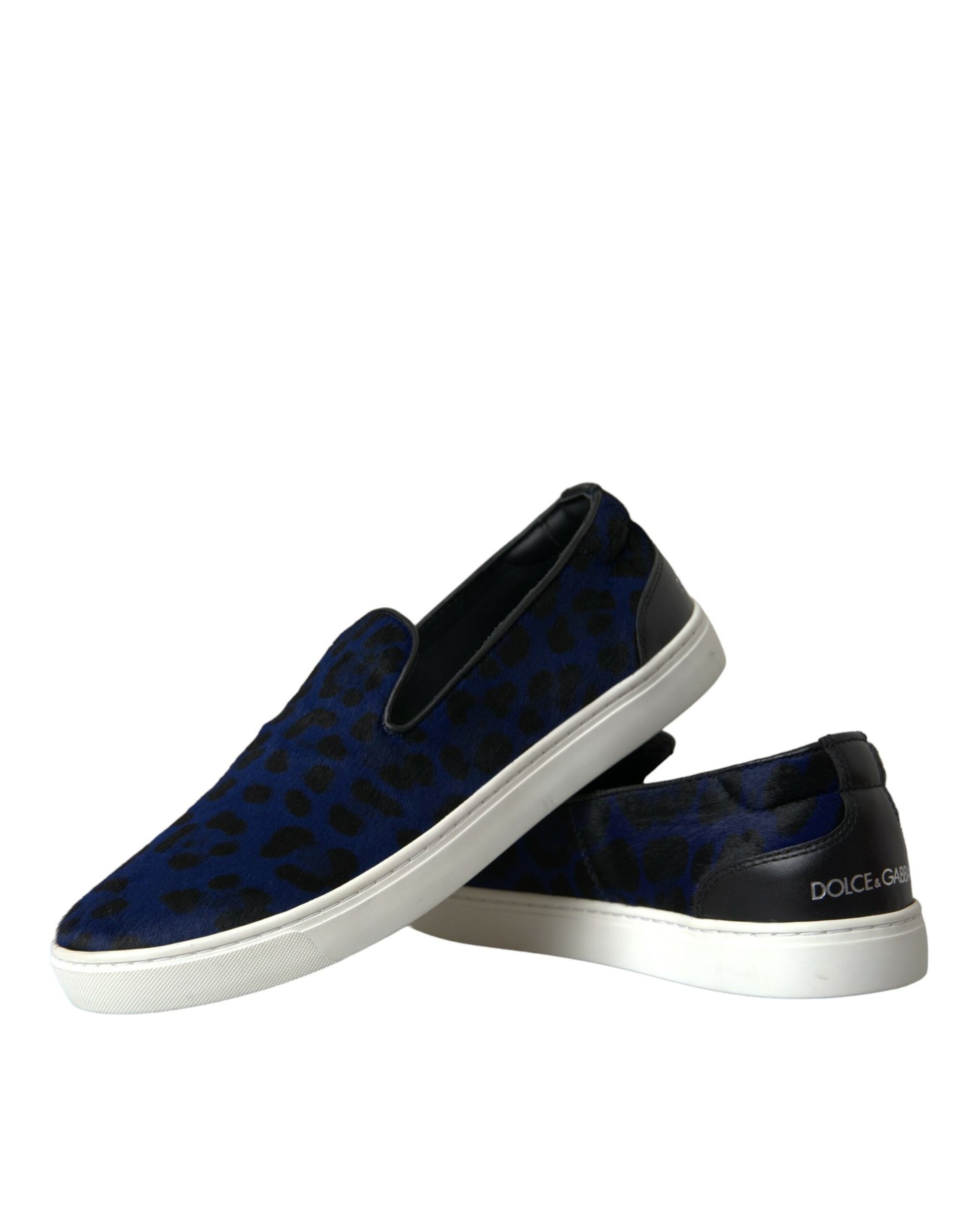 Pair of blue slip on shoes with white soles and black laces