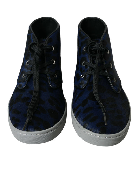 Pair of blue suede boots with laces and a zipper on top