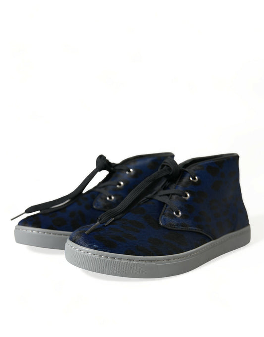 Pair of blue suede boots with white soles and laces