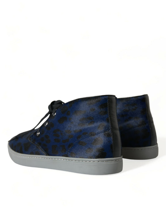 Pair of blue suede boots with white soles and laces
