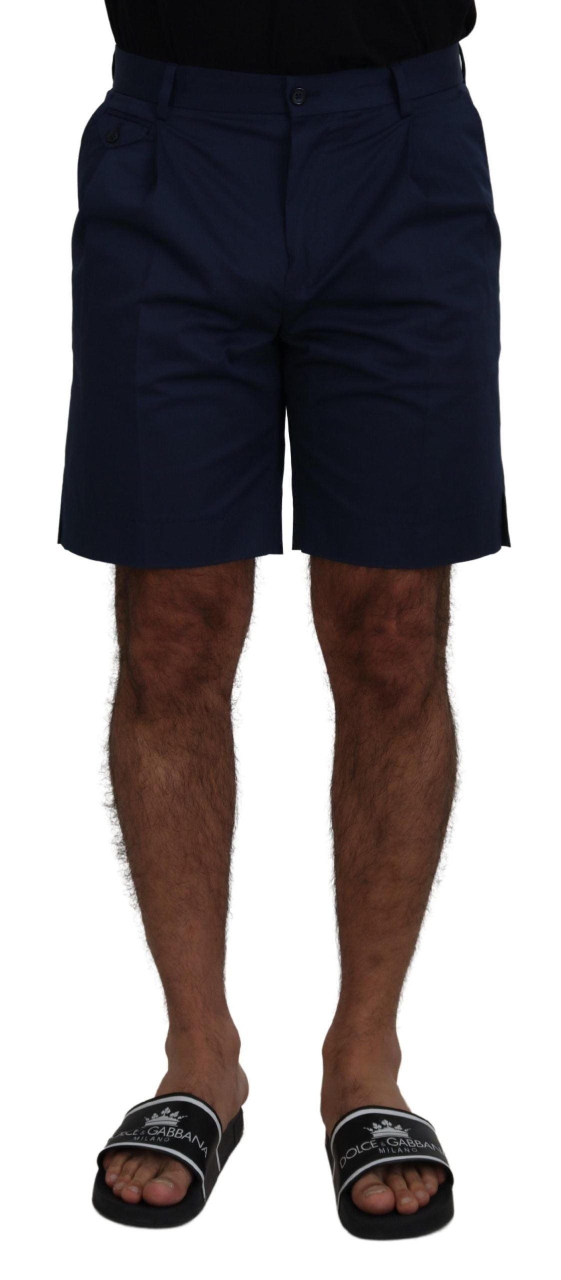 Man wearing navy blue shorts and black sandals