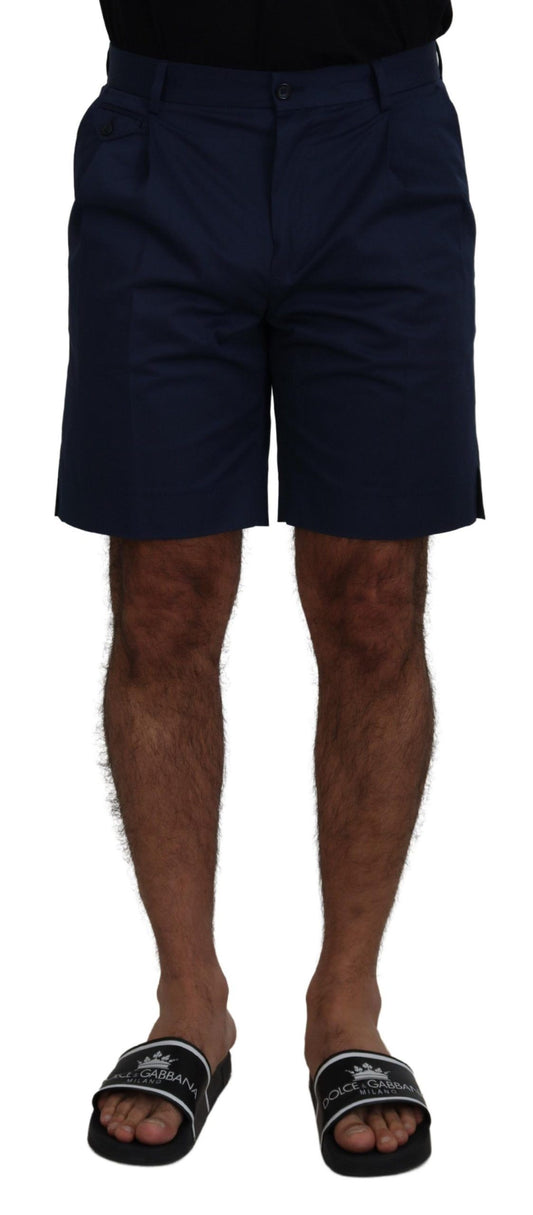 Man wearing navy blue shorts and black sandals