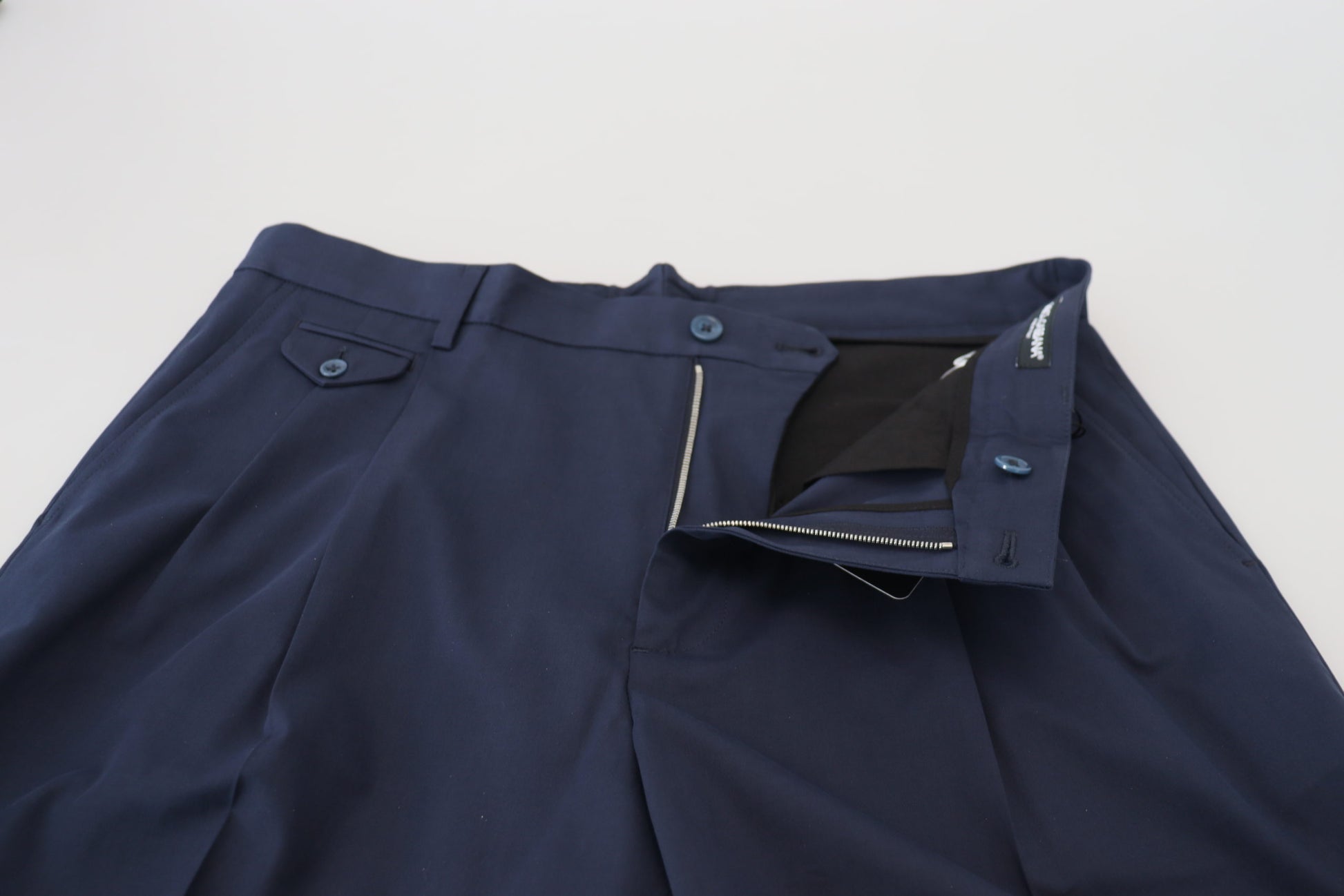 Navy blue chino pants with zippered pockets and waistband, cotton stretch fabric