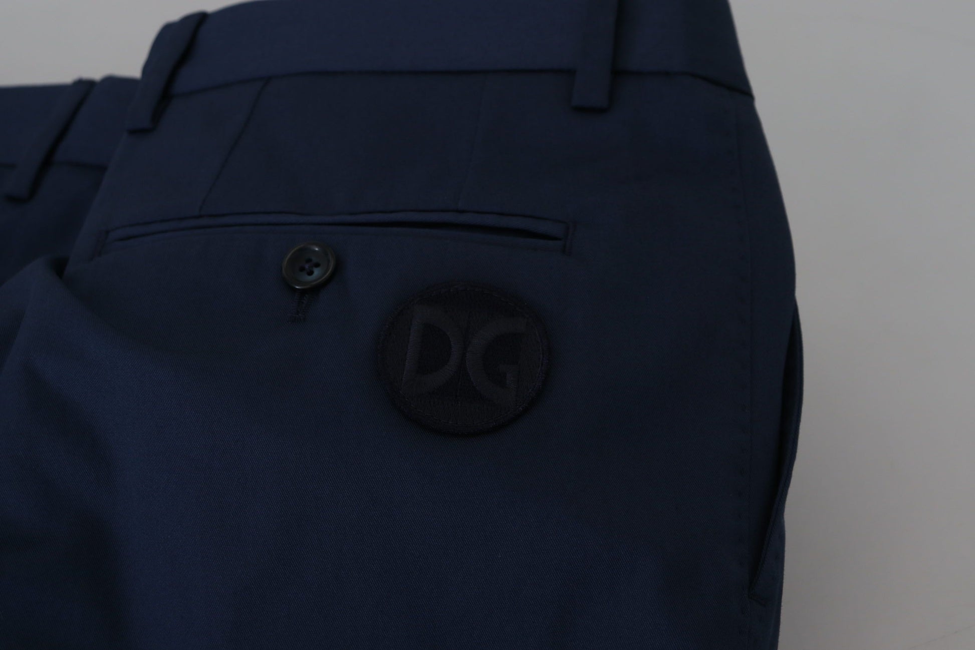 Navy blue pants with a logo on the left leg