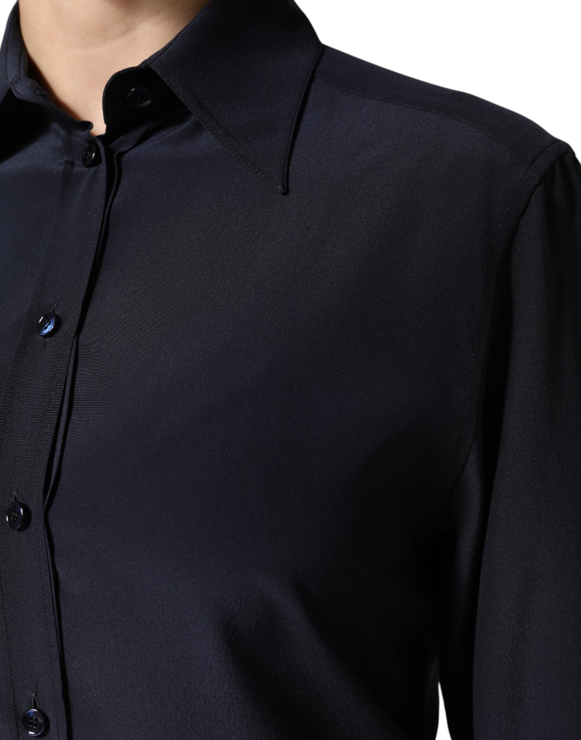 A long sleeve blue collared dress shirt top
