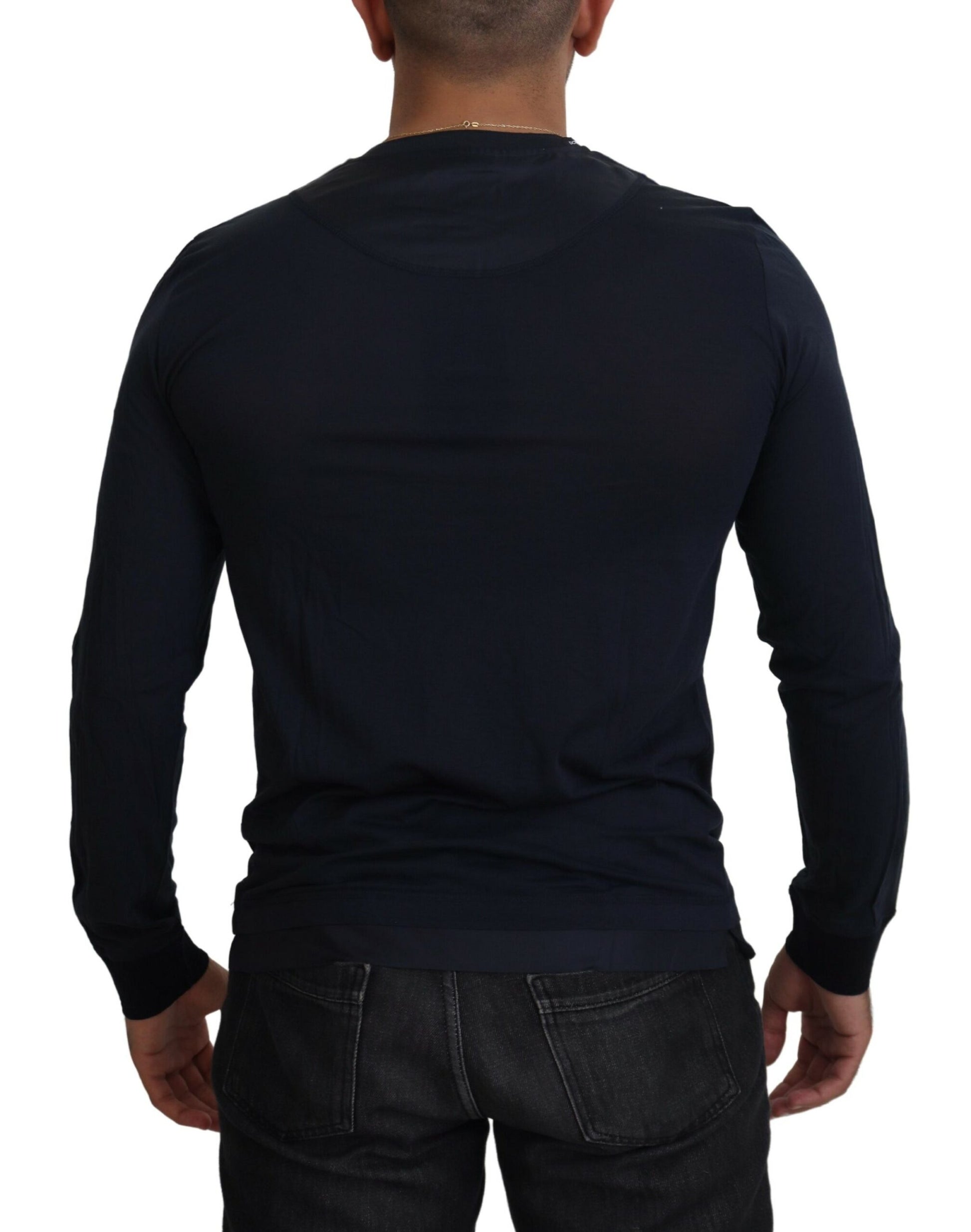 Man wearing dark blue long sleeve shirt and jeans