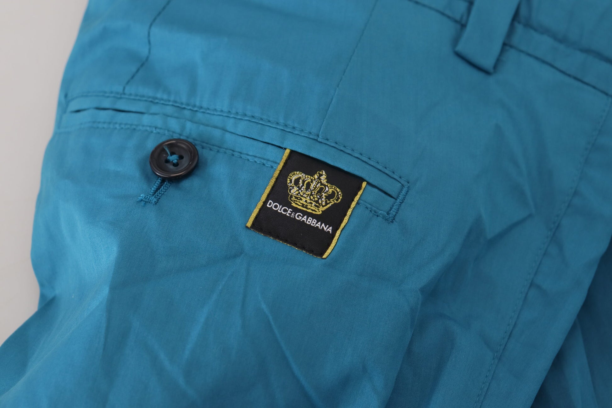 Blue pants with a logo on the left chest pocket