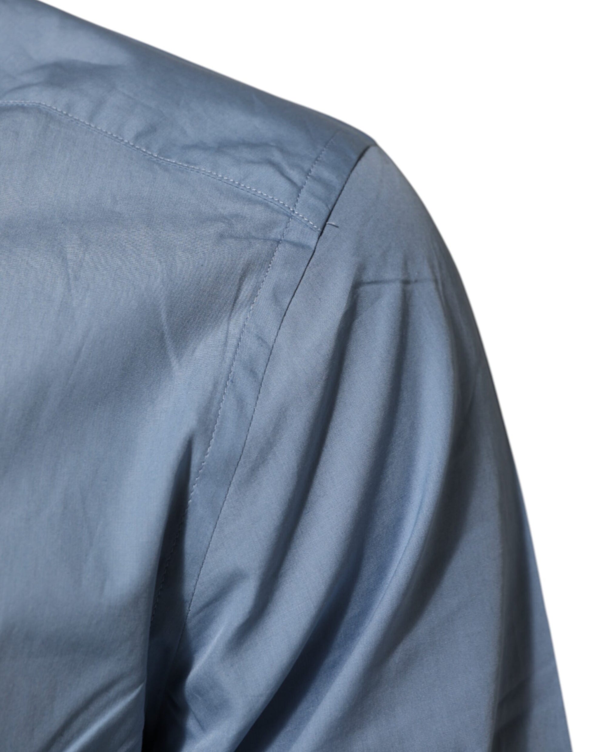 A blue collared dress shirt with gold accents